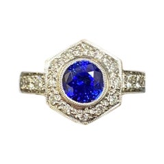 Anello in platino inciso a mano con 2 carati di zaffiro blu di Ceylon e diamante aureolato in platino