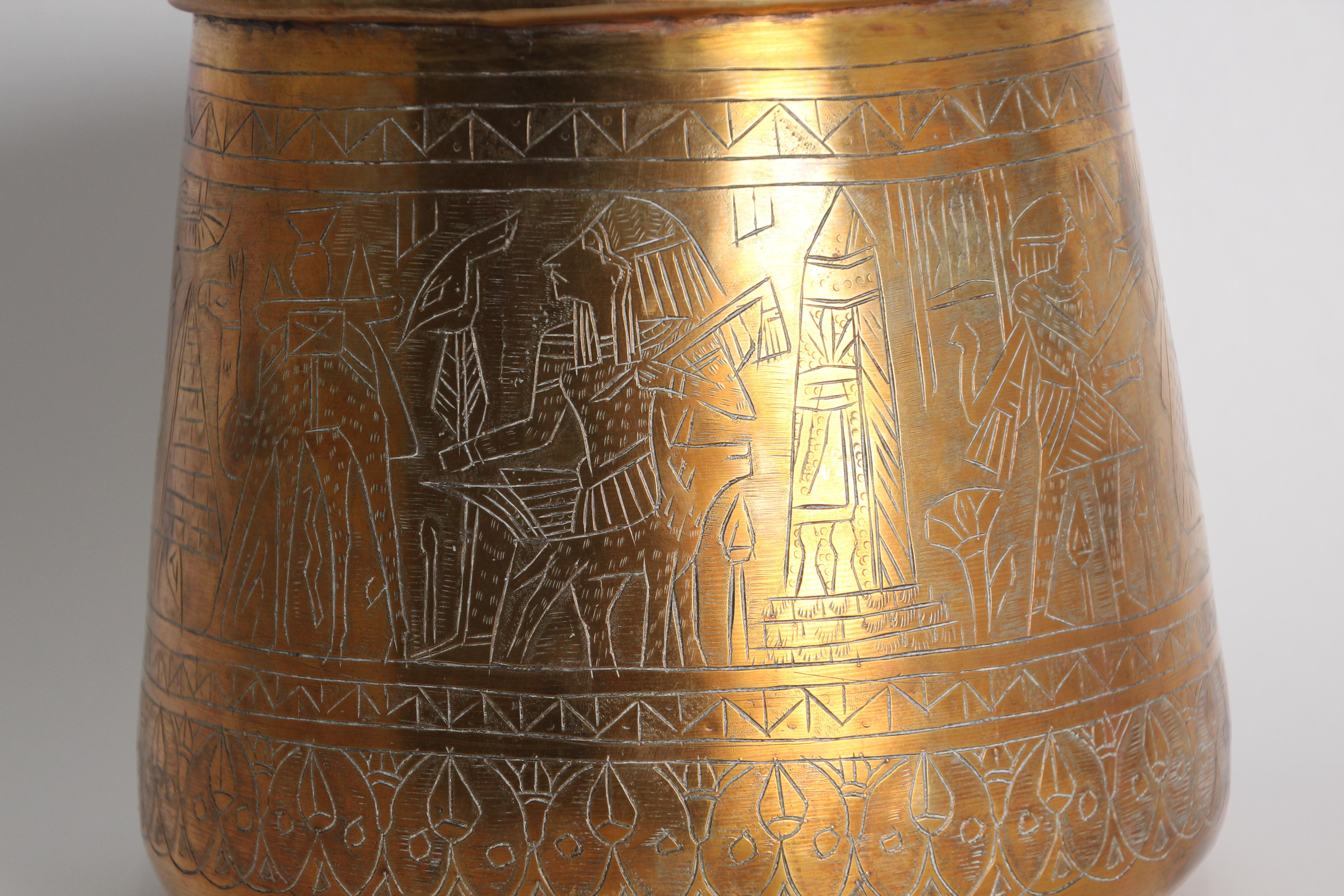 Middle Eastern Egyptian hand etched polished brass vessel.
Could be used as a vase or Jardiniere, indoor or outdoor.
Arabic Mameluke revival style brass vessel with figural scenes and pyramid architectural and geometric designs hand-hammered on