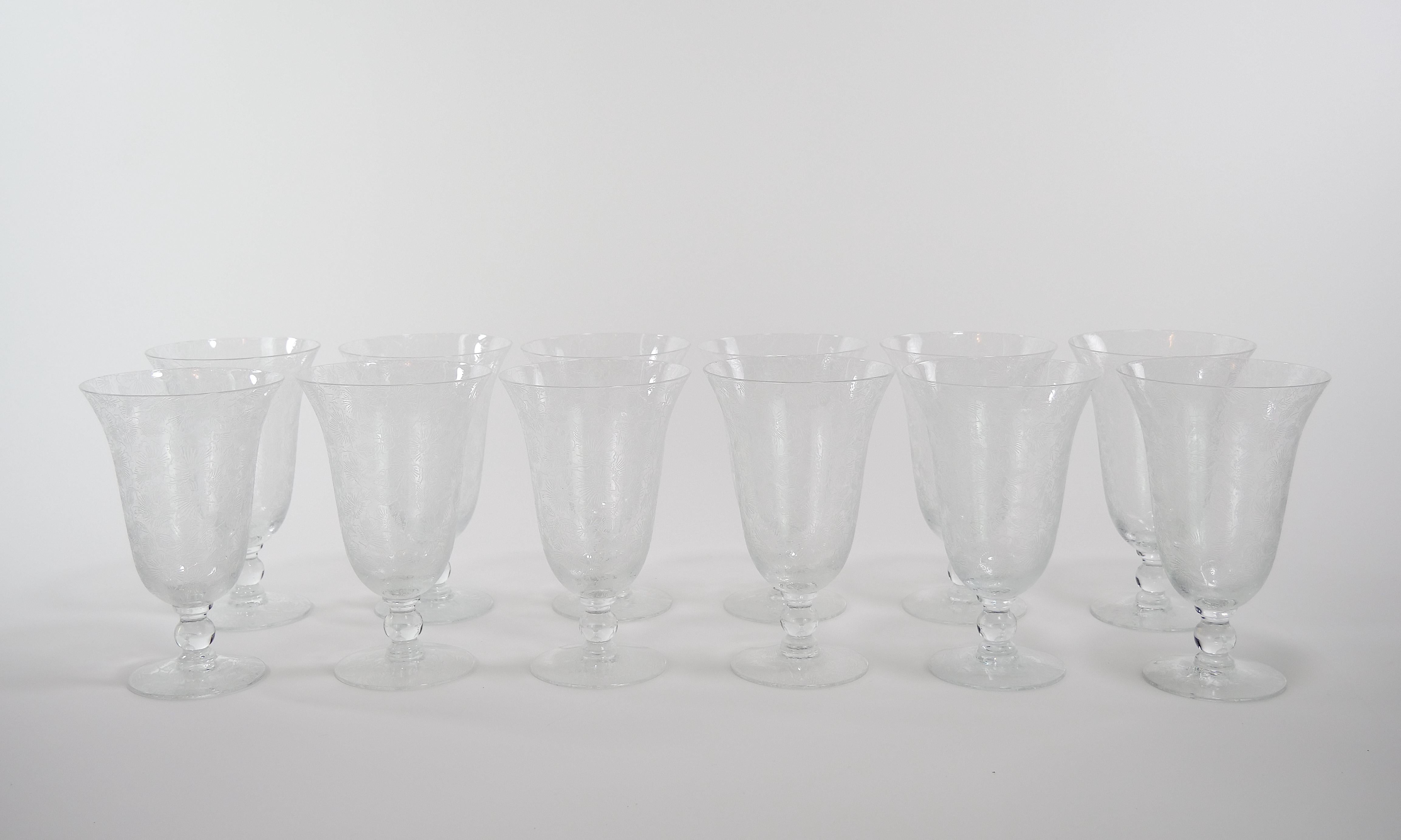 Mid 20th century beautifully hand etched exterior floral design barware / tableware glassware service for 12 people. Each glass is in great condition. Each one measures 6.75 inches high and 4 inches top diameter, base is 3 inches diameter.
