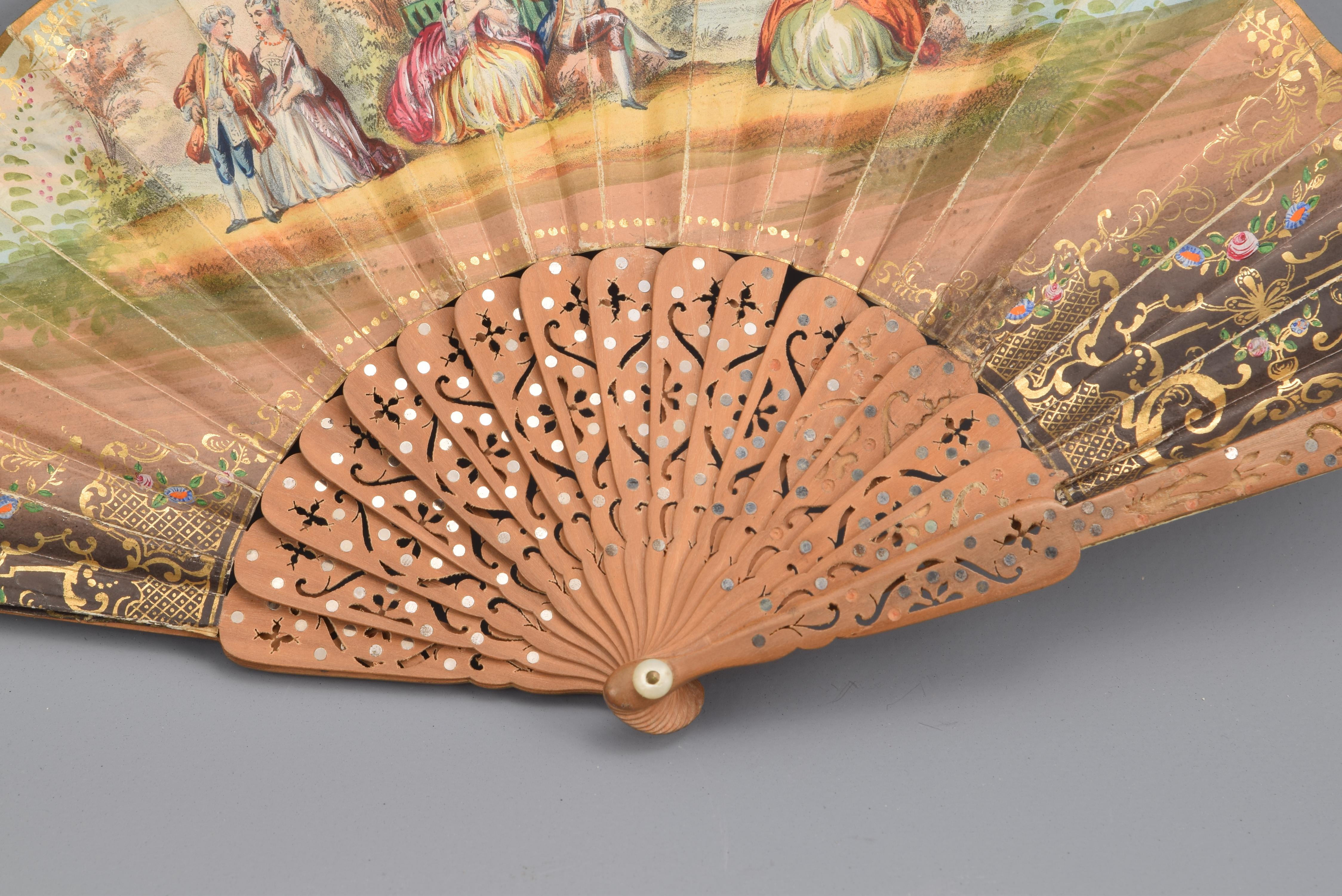 Hand fan. Wooden linkage, 19th century.
Fan with openwork wooden rods that presents a country and a court scene in the country, decorations enhanced with plant elements and compositions of mesh and dots. This scene, with two couples and a lady