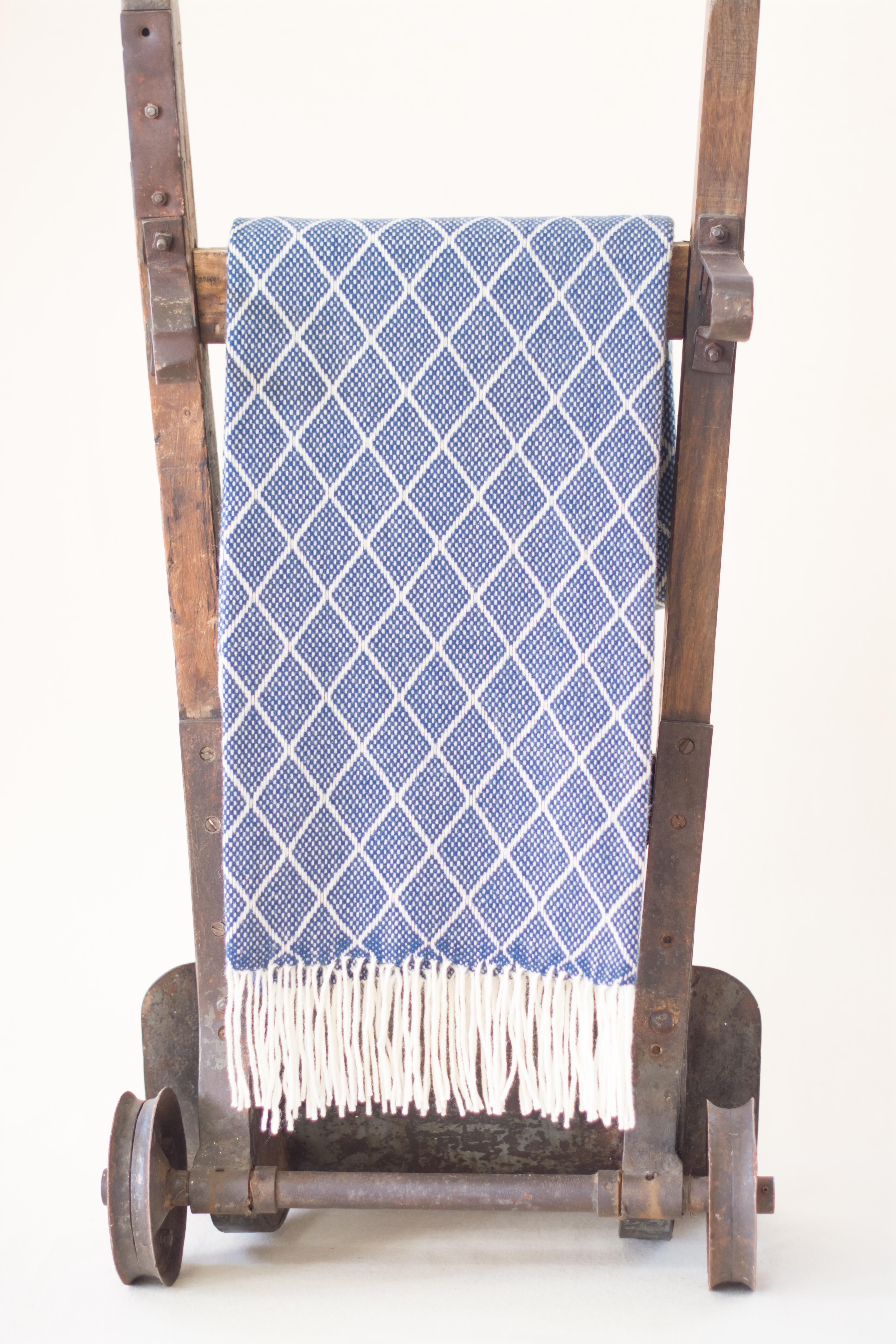 The Otilia Blue denim Diamond pattern blanket/throw has been created by an incredible and unique family owned weaving and textile company in Portugal. This company impressed us so much by their commitment to working with the environment, their