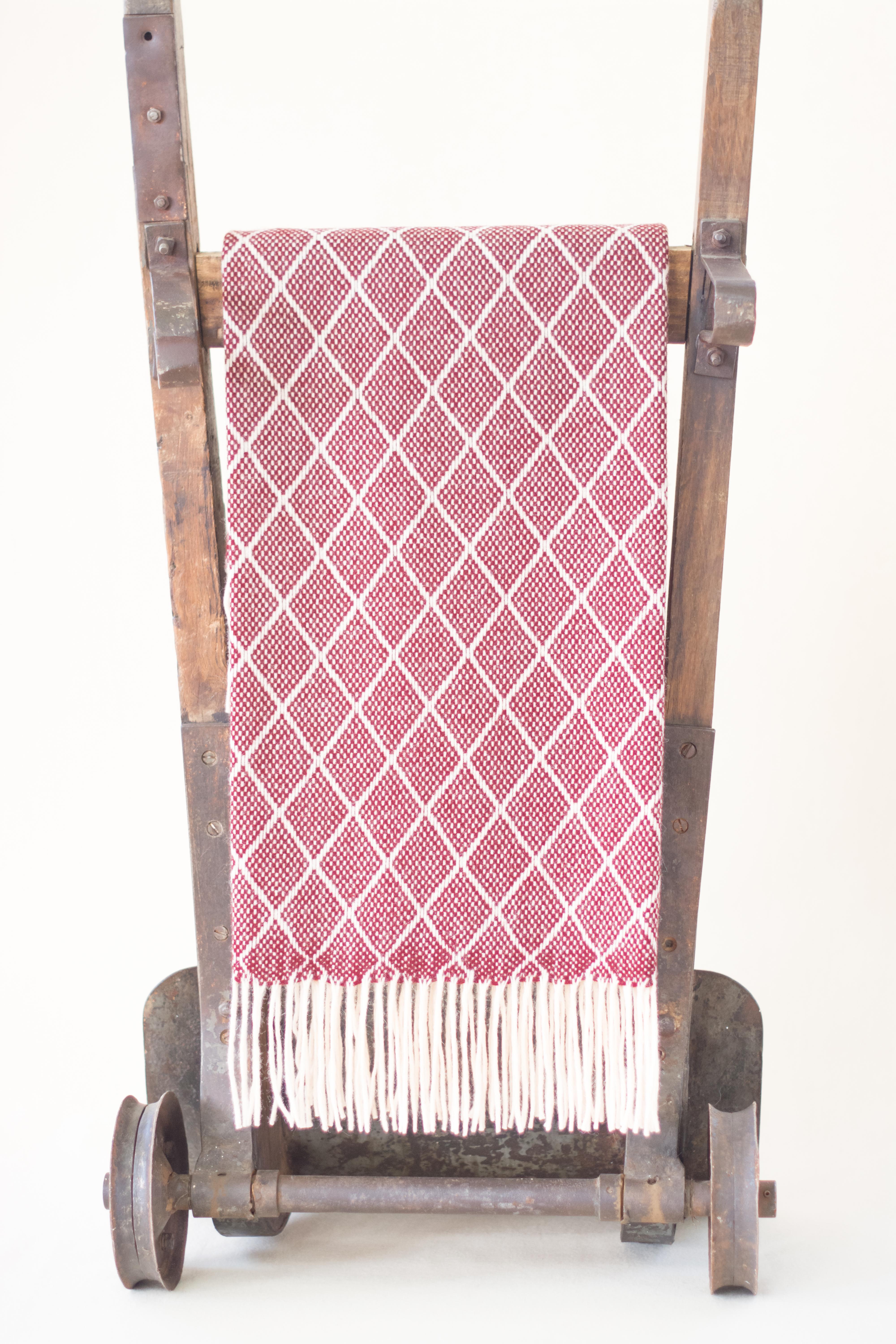 The Otilia Bordeaux color diamond design pattern blanket/throw has been created by an incredible and unique family owned weaving and textile company in Portugal. This company impressed us so much by their commitment to working with the environment,