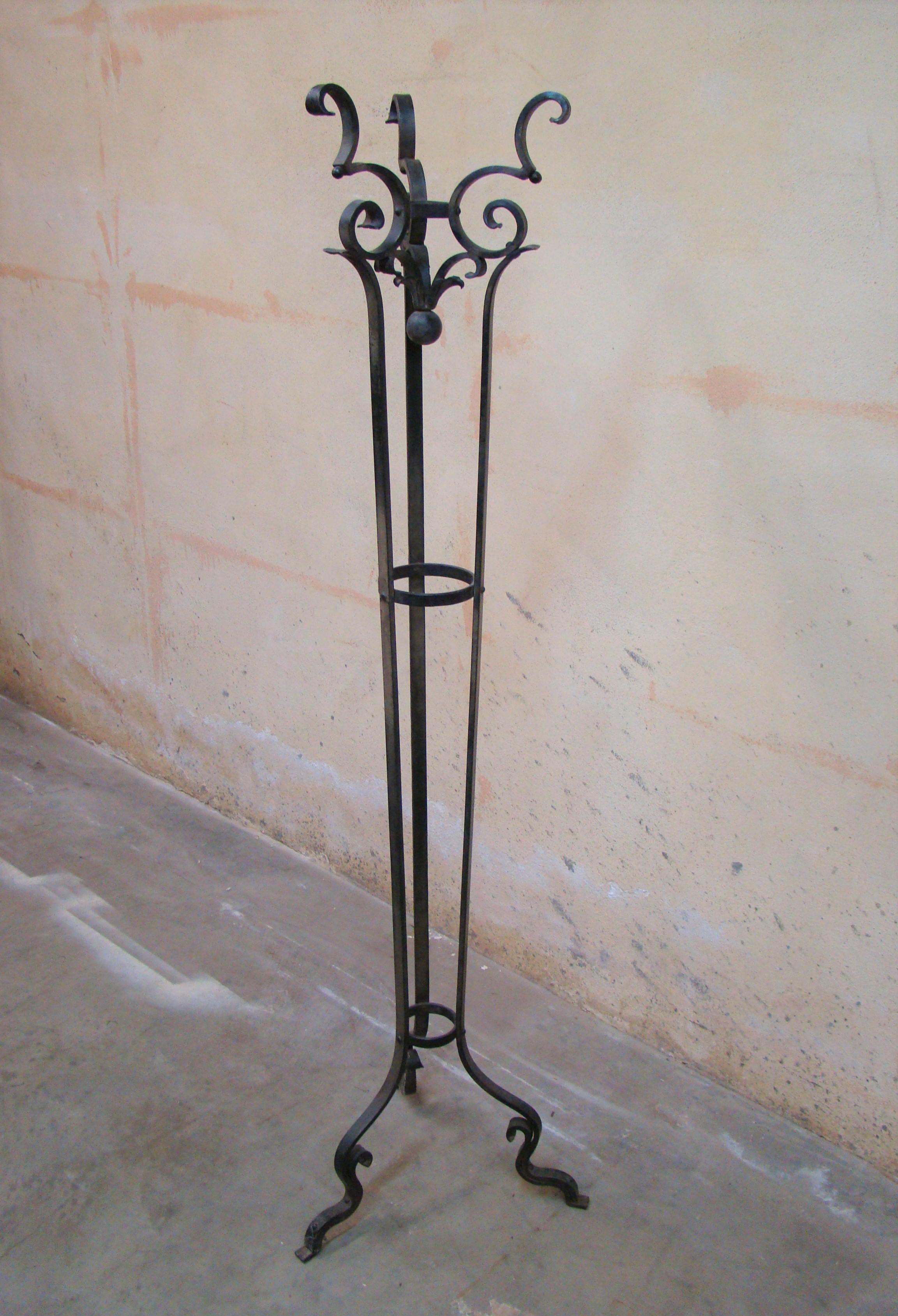 Antique coat stand, circa 1930s beautifully hand forged and scrolled from flat iron stock. Slightly Gothic, it features an inverted ball finial and circular bands that will accommodate your umbrella. Stable and solid, absolutely functional and well