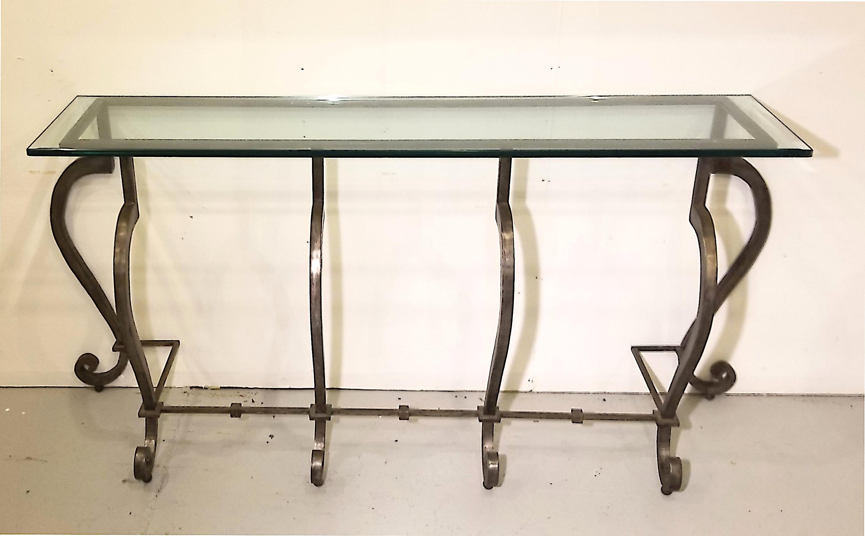 I great item with lots of presents. Hand forged wrought iron console made in California in the 1950s. Purchased from an estate in southern California, this hand created item is in top condition and is as graceful as it is strong. Glass top is 3/4