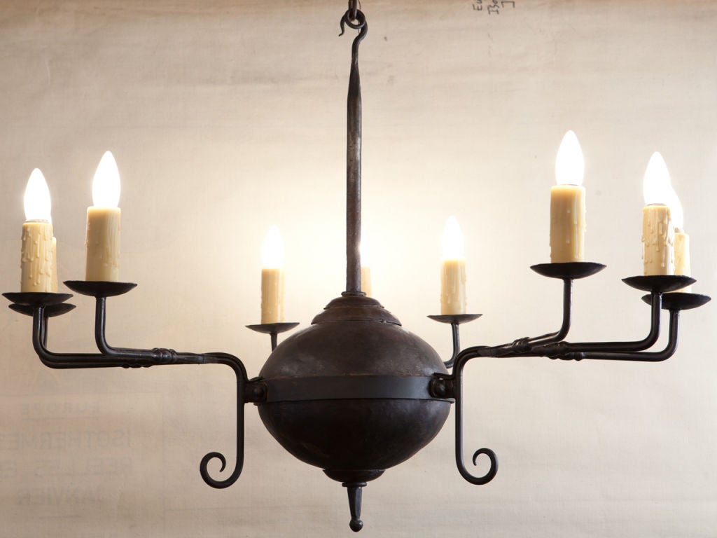 This hand-forged Iron chandelier is a classic reproduction light of our design. The three arms have three lights each for a total of nine candelabra sockets. Height is to the top of the hook. Newly wired in the USA with all UL listed parts. Comes