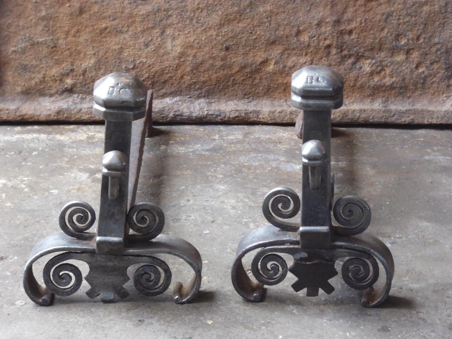 18th century French andirons made of wrought iron. The style of the andirons is Louis XV, and they are from that period. They are in a good condition.
