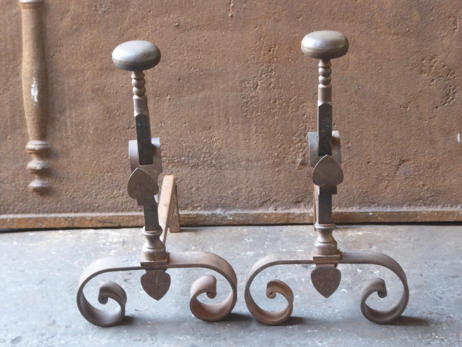 19th century French Napoleon III andirons made of hand forged wrought iron. The andirons have spit hooks to grill food. They are in a good condition.