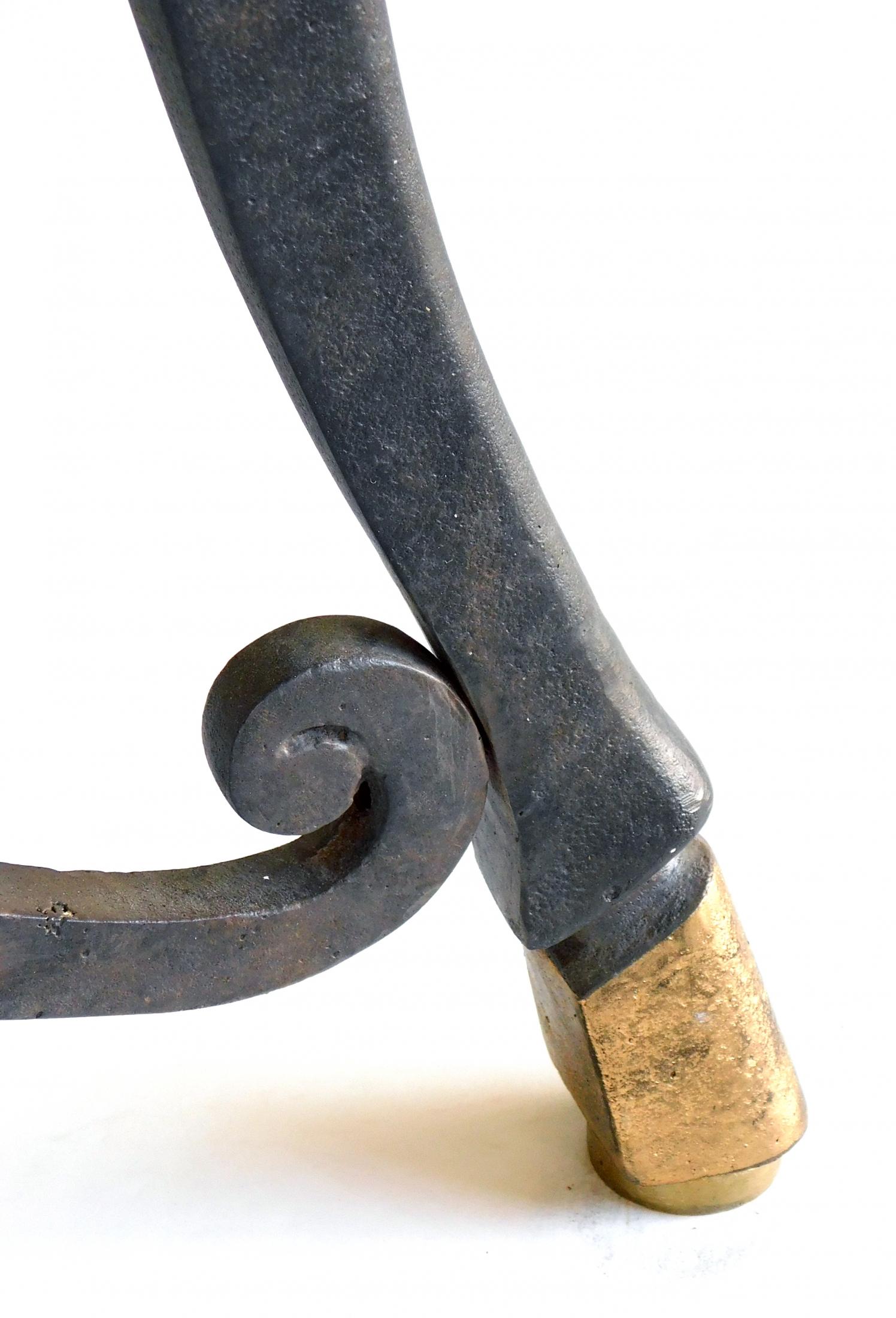 The well-figured marble top resting on an iron tripod frame with rope-twist perimeter ring surrounded by 3 splayed supports ending in hoof feet; joined by a shaped stretcher.