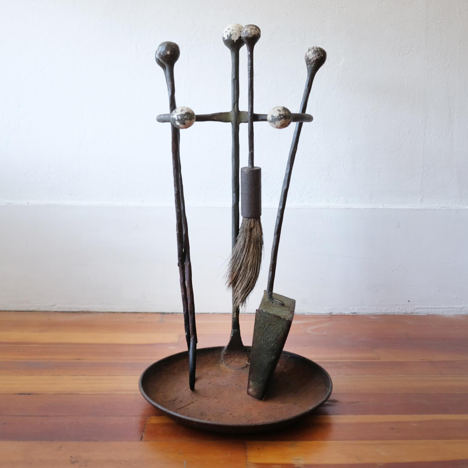 Hand-forged solid iron fire tools on a stand. Solid metal ball handles. Horse hair brush. Great wear and patina.