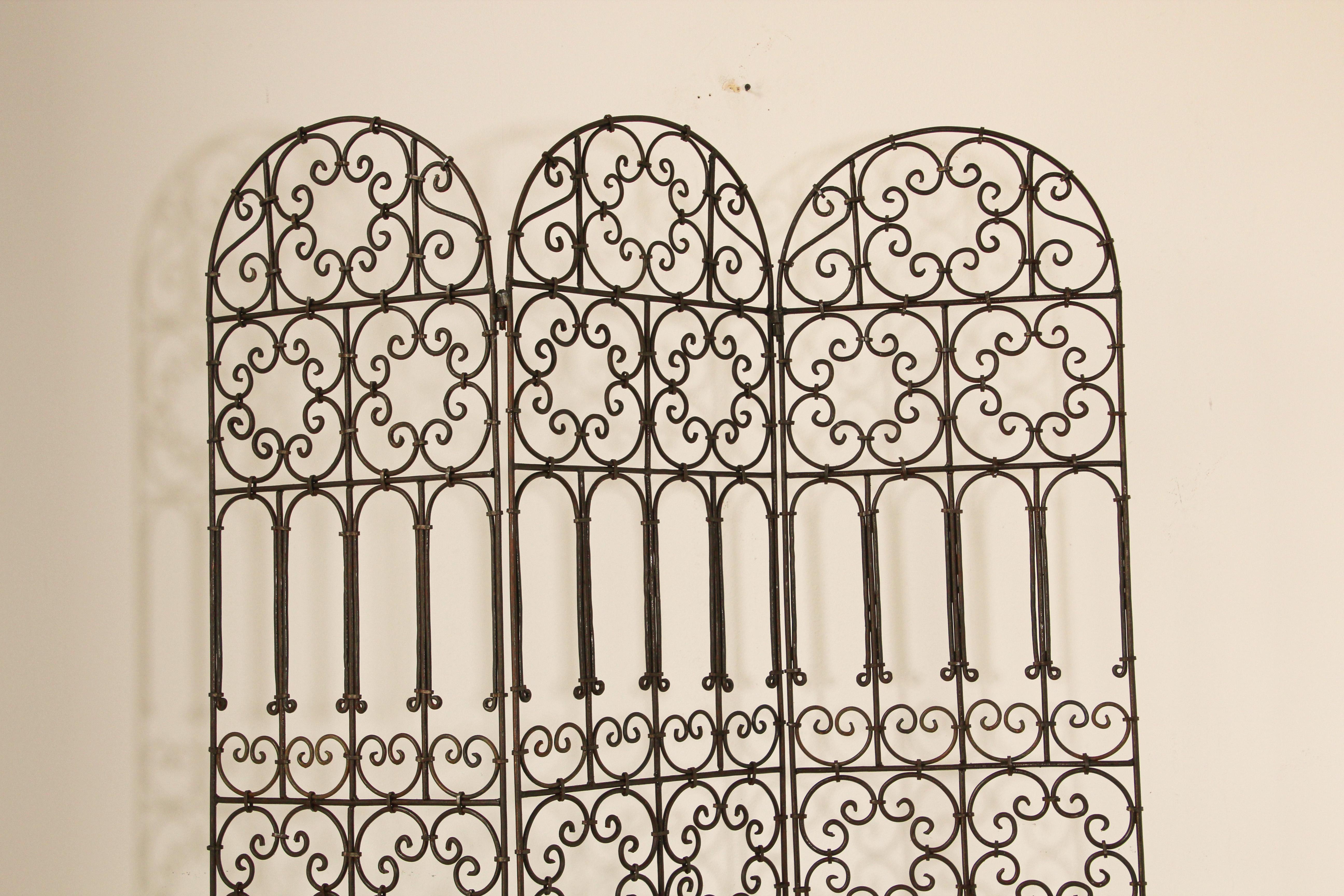 Hand forged folding Moroccan iron screen with three panels decorated with Moorish designs.
Classic and elegant Art & Craft this highly embellished, detailed folding screen divider in the Mediterranean Spanish style iron art work would embellish any