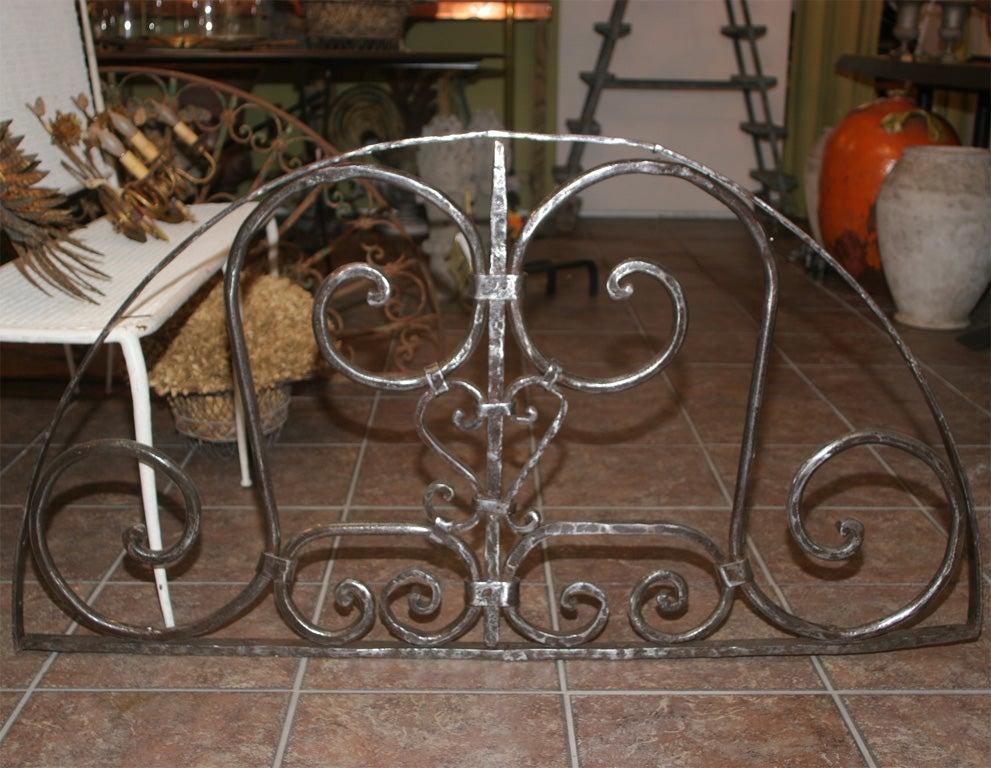 Beautiful vintage wrought iron door transom grill.