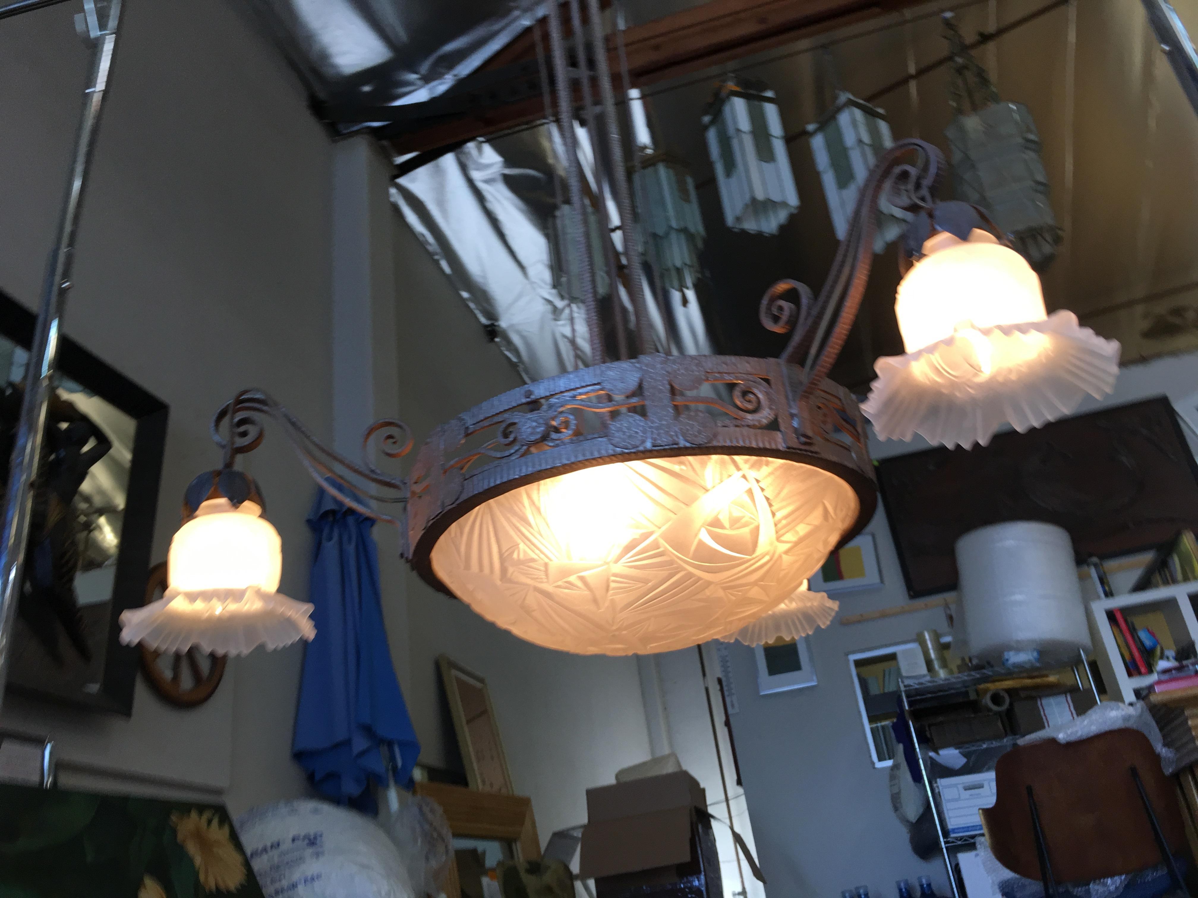 Hand-forged Mission style chandelier with 3 arms extending outward each holding a light and center dome light.

addx1