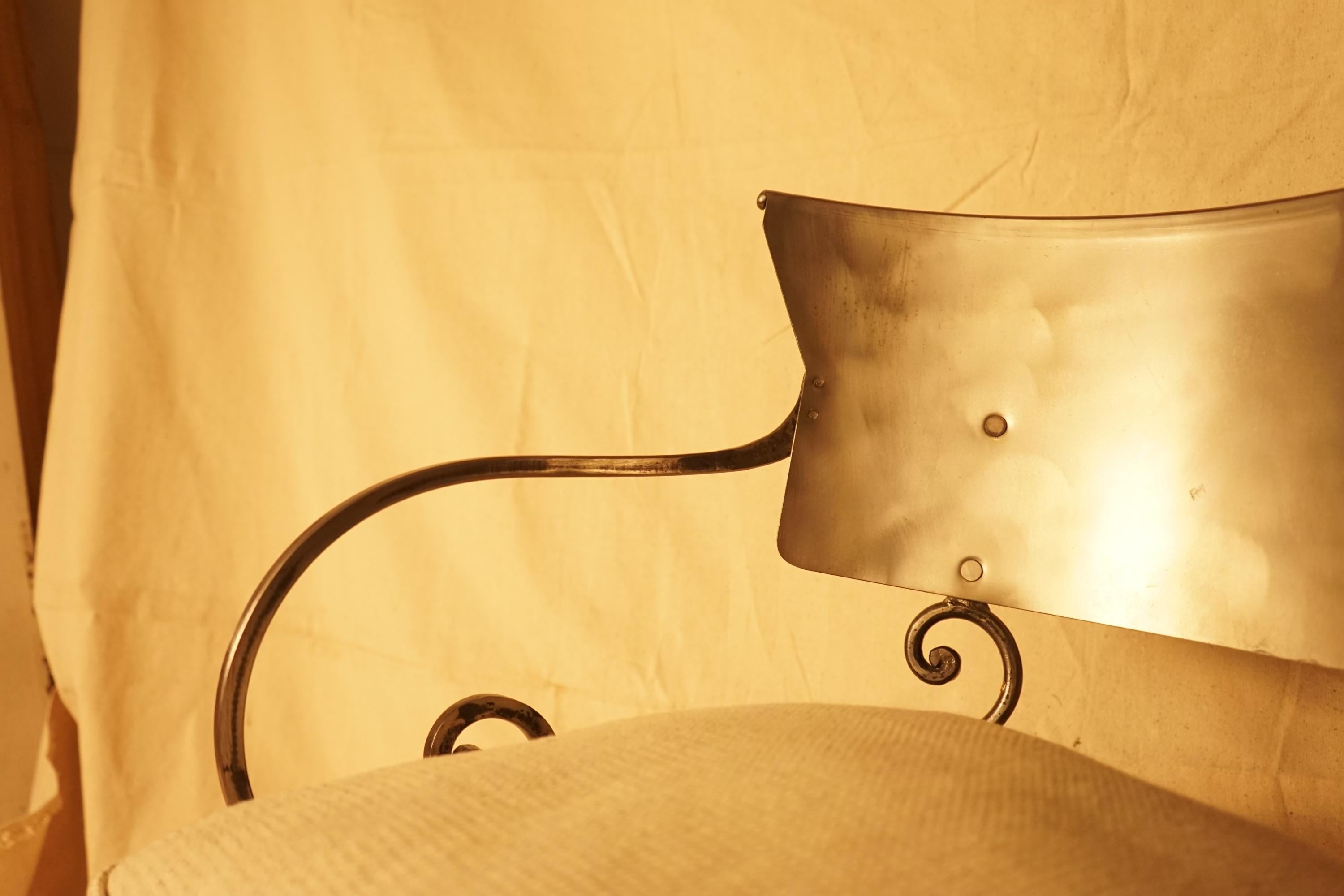 Stylish hand forged steel klismos style arm chair having beautiful silhouette and custom wood seat cushion.
arm height 26
seath depth 16