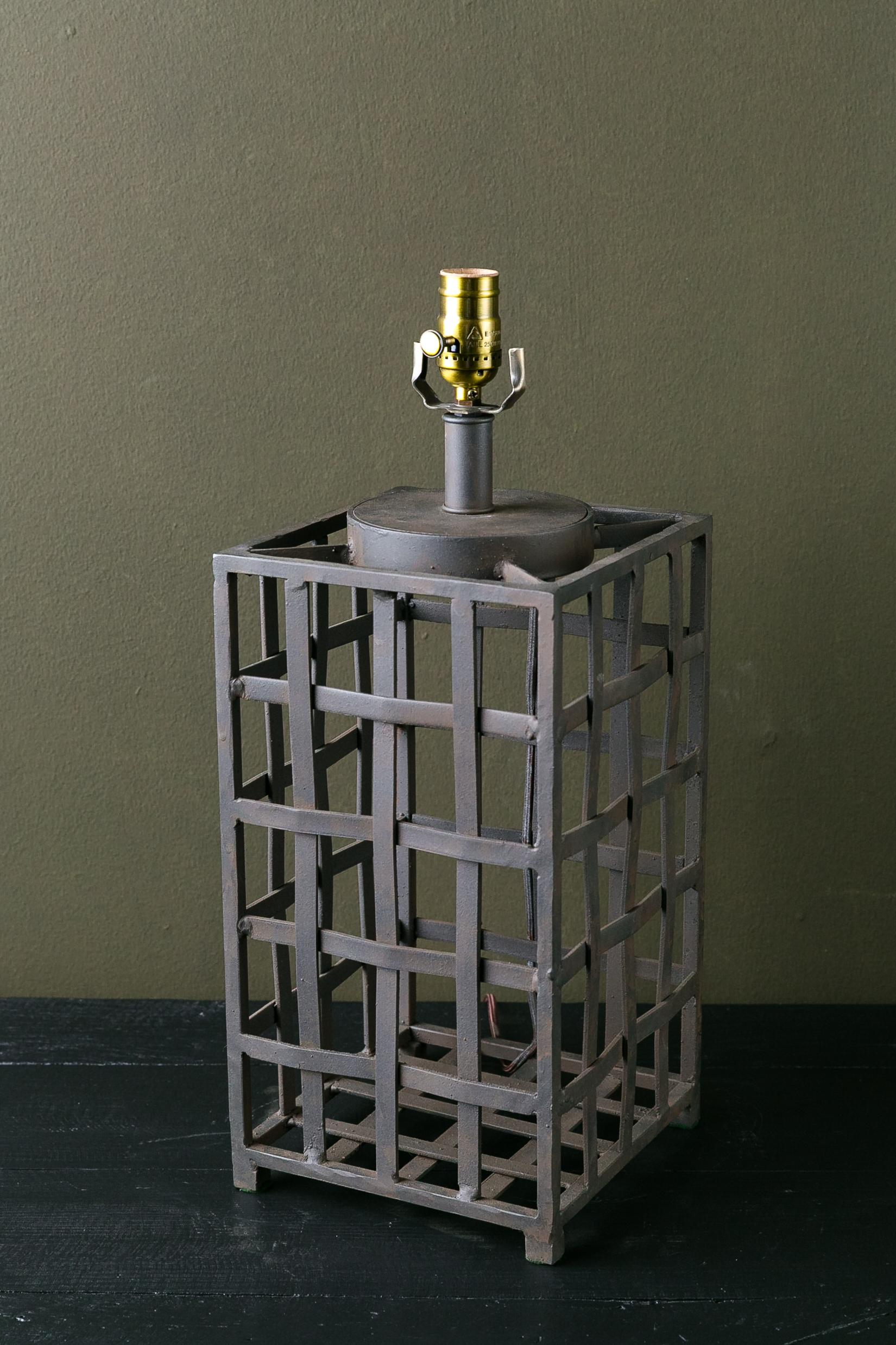Our own design. Hand forged woven iron table lamp. Manufactured in the USA and wired in USA with UL-approved parts. Nice adaptable style that would look good in rooms both classic and contemporary.