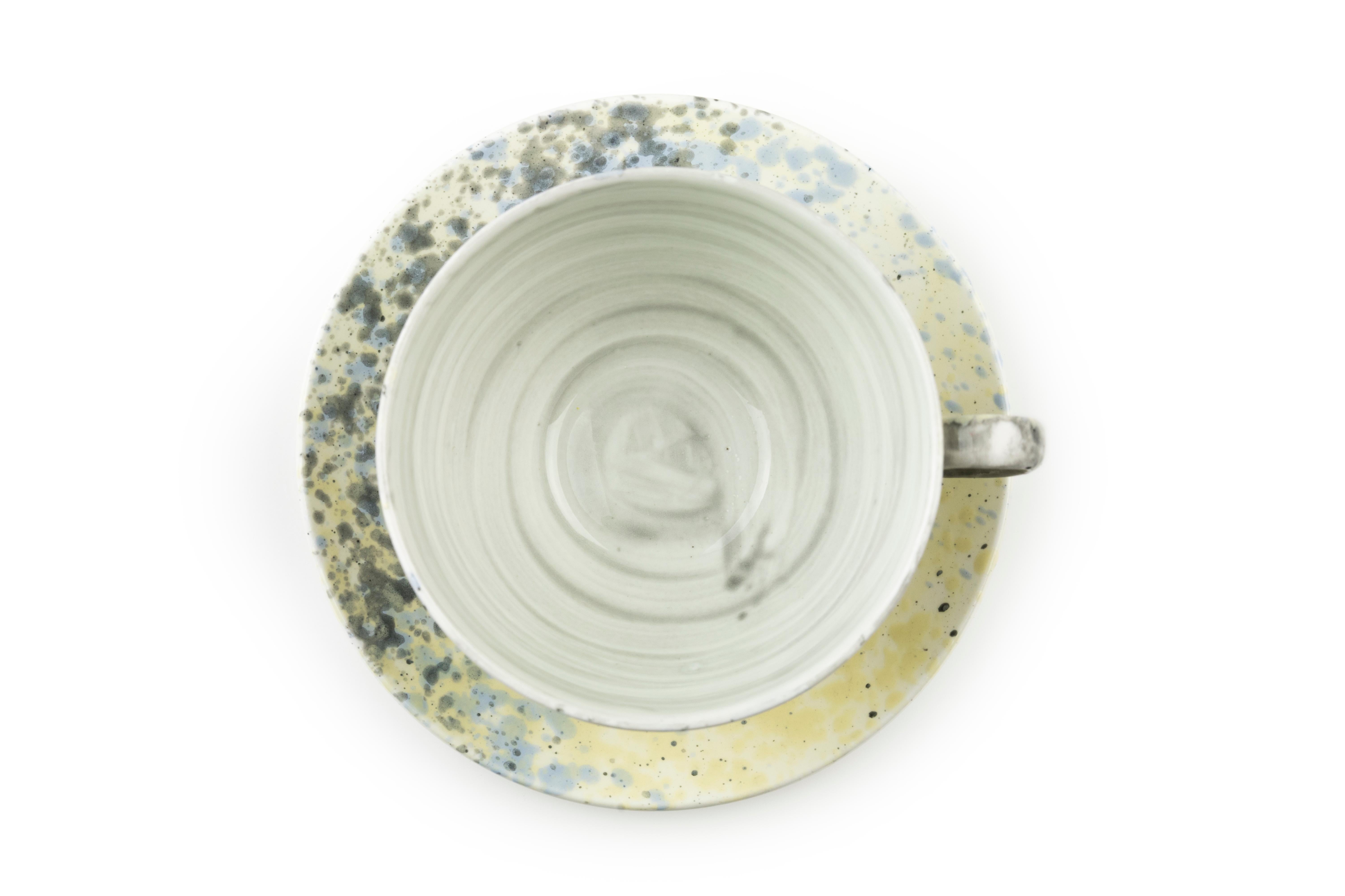 This tea cup and saucer are available in a variety of colors and finishes to be mixed and matched. When purchasing this set please specify the color and finish for each item.

Color options:
Solid grey
Solid blue
Grey splatter
Yellow