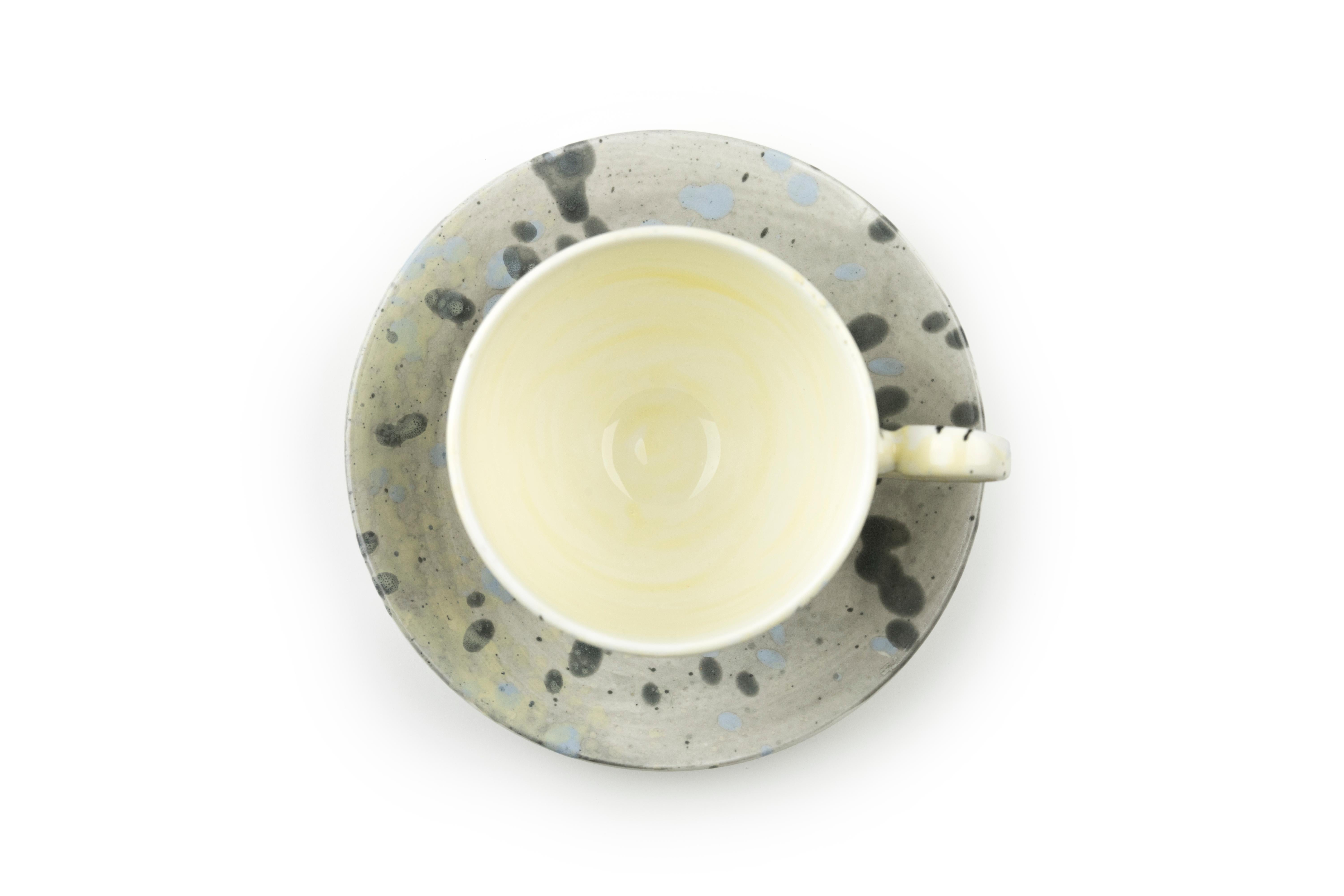 This tea cup and saucer are available in a variety of colors and finishes to be mixed and matched. When purchasing this set please specify the color and finish for each item. 

Color options:
Solid grey
Solid blue
Grey splatter
Yellow