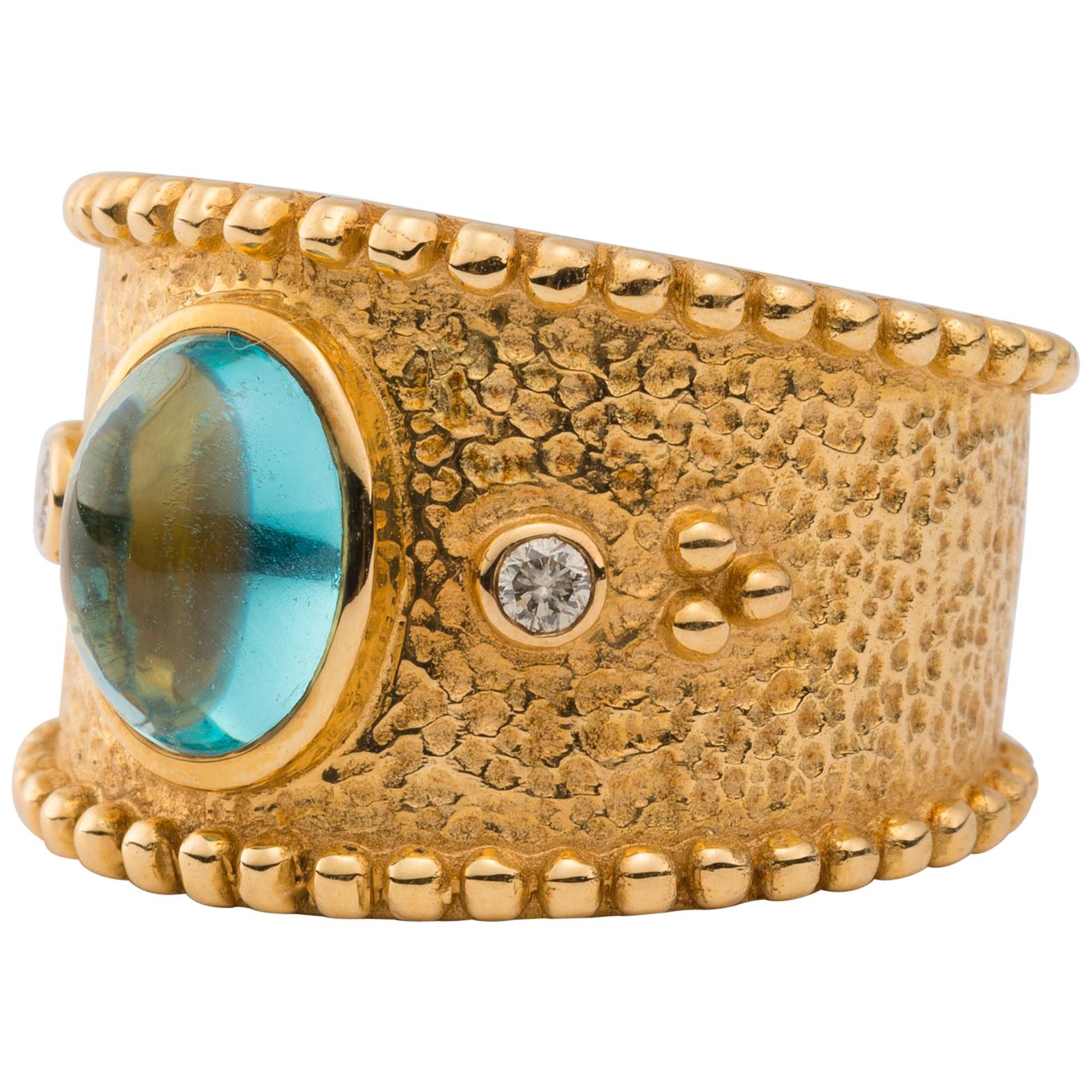 18 Karat Gold Ring with Oval Cabochon Blue Tourmaline and Diamonds