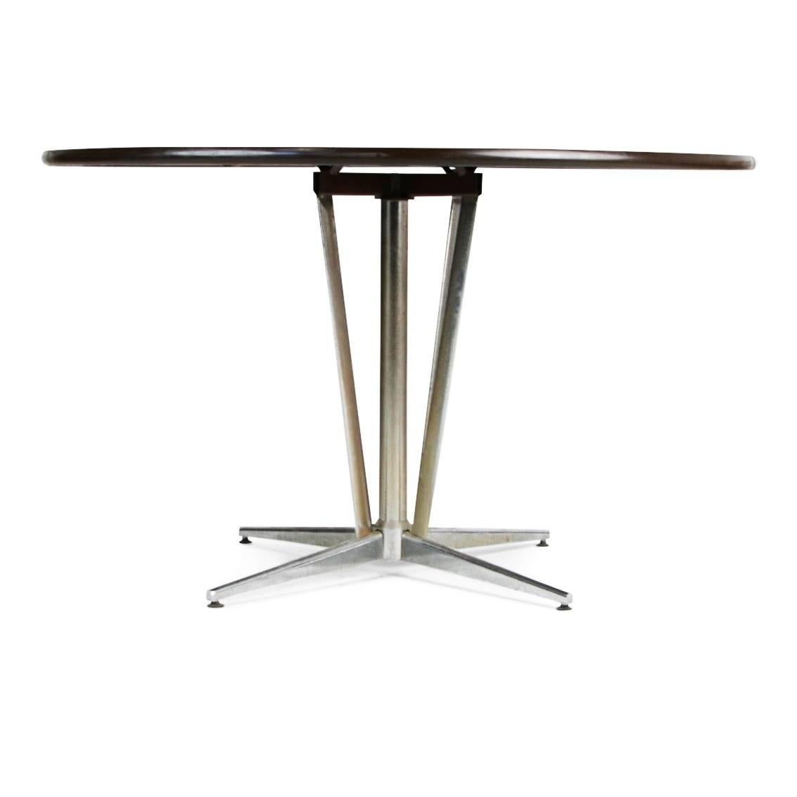 Mid-Century modern table supported by a chrome base and topped with an attractively decorated surface featuring hand-hammered geometric copper designs. With copper being a top trend currently, this beautiful piece will dazzle in any space. 

This