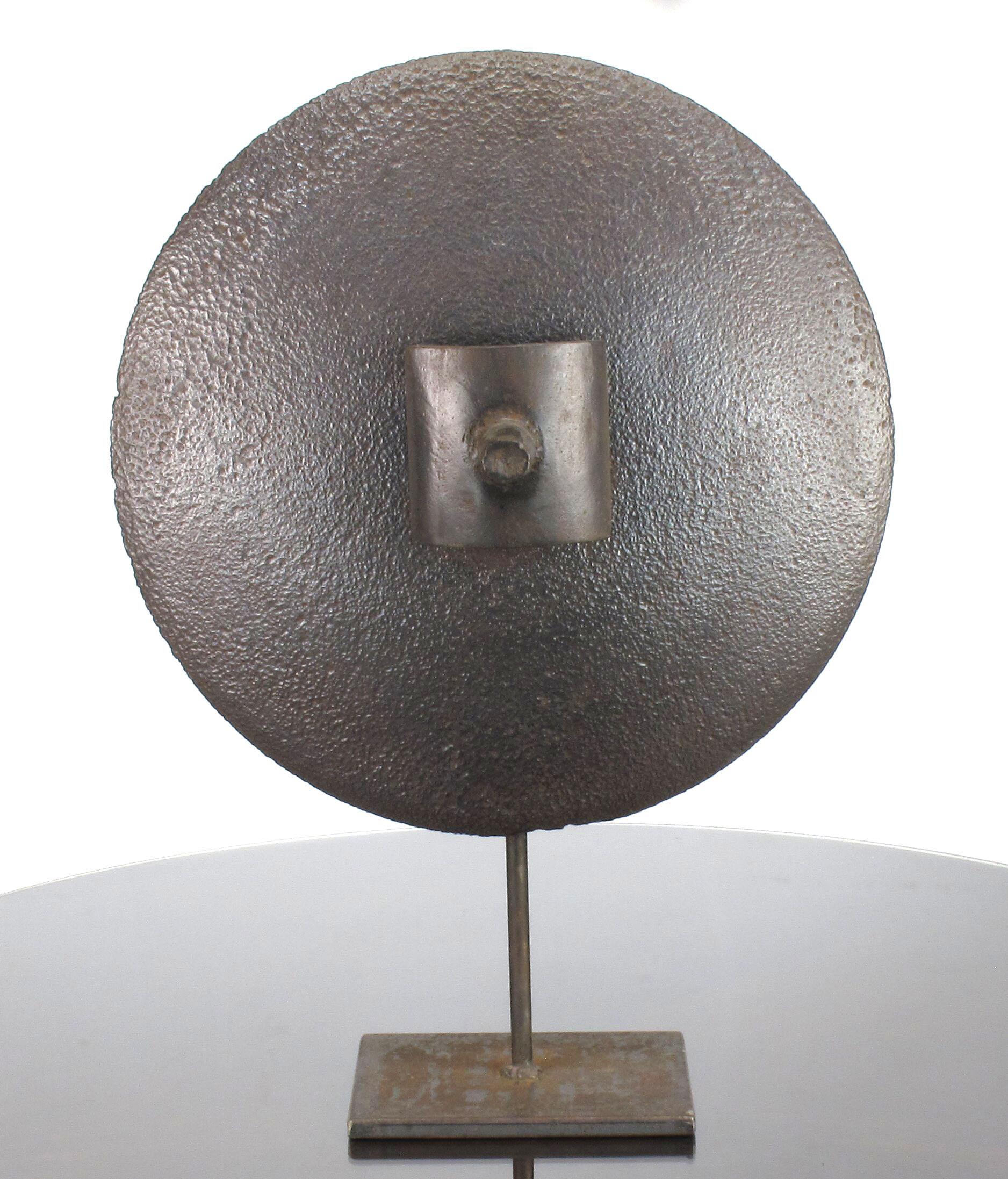 Striking hand-hammered iron disc sculpture with floating center handle. Constructed of various iron pieces that were handwrought and welded together to create a floating 18