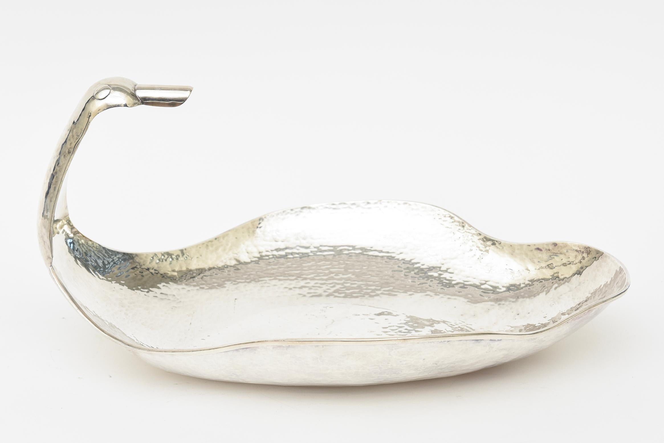 This monumental whimsical vintage hand-hammered silver plate bowl, serving piece or barware has an exaggerated duck head with large beak as one of the curved sides. It has scalloped sides. It was professionally polished to the best it can be. No