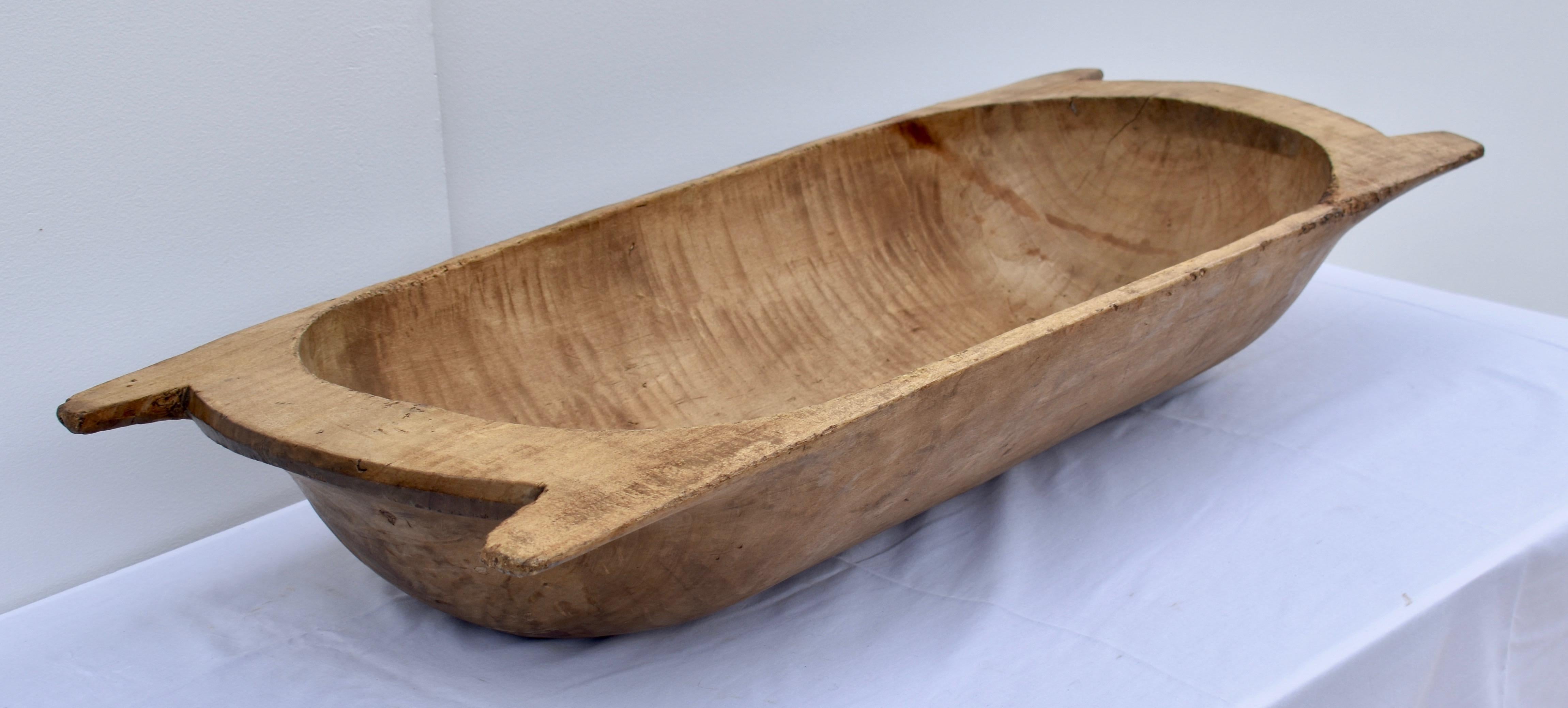 Our European antique wooden dough bowls or trogs are hand-hewn from whole split logs. They feature remarkable handiwork and a beautiful patina, especially when viewed from the underside. They all show signs of purposeful use. Some have small cracks,