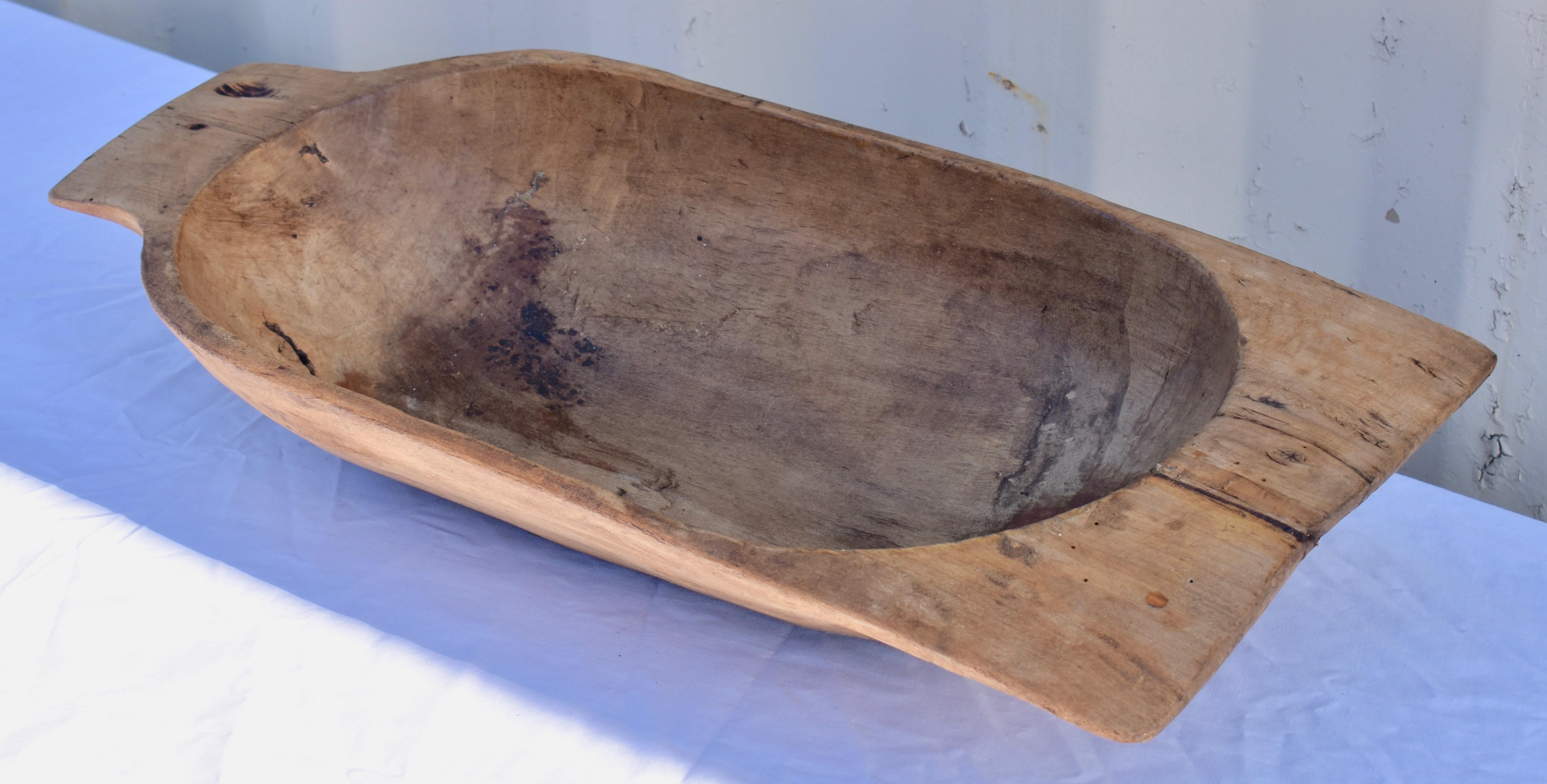 Our European antique wooden dough bowls or trogs were hand-hewn from whole split logs. They feature remarkable handiwork and a beautiful patina, especially when viewed from the underside. They all show signs of purposeful use. Some have small