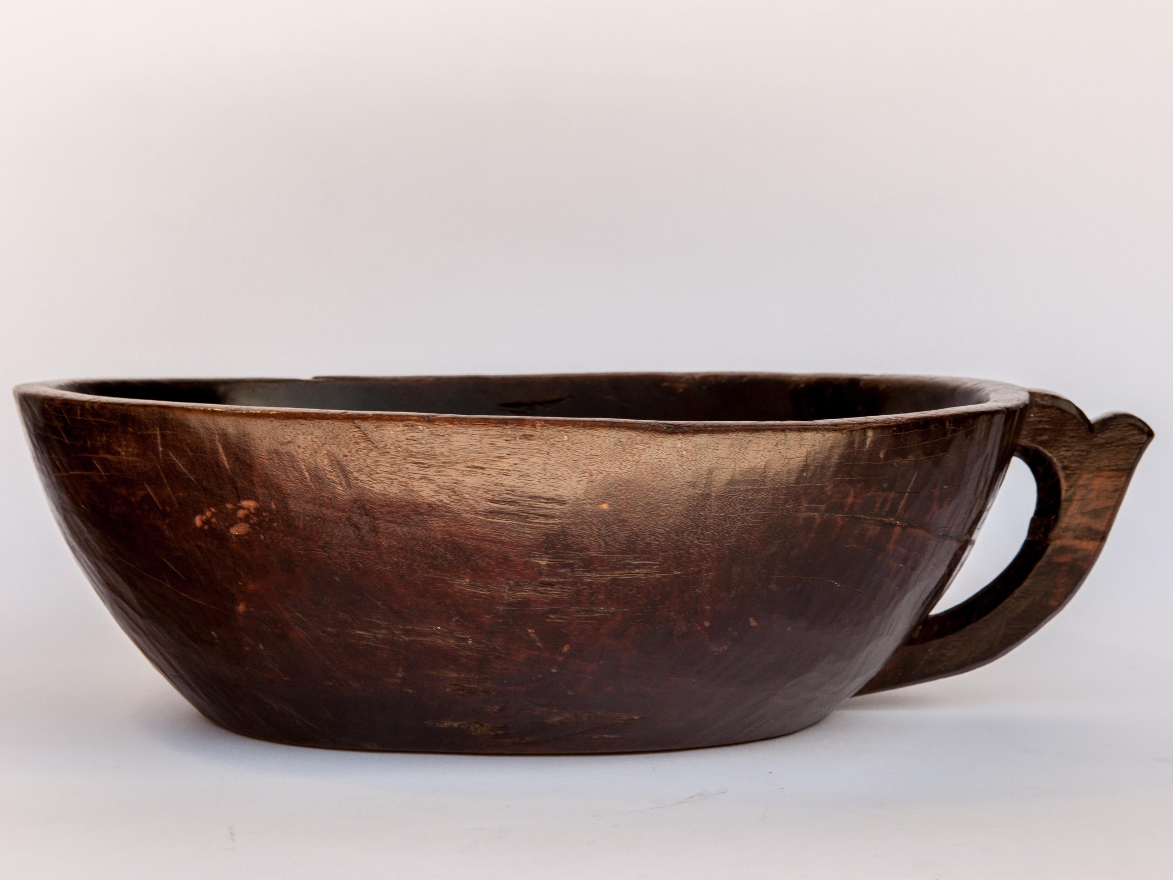 Hand-Carved Hand Hewn Wooden Bowl with Handle from Sulawesi, Indonesia, Mid-20th Century