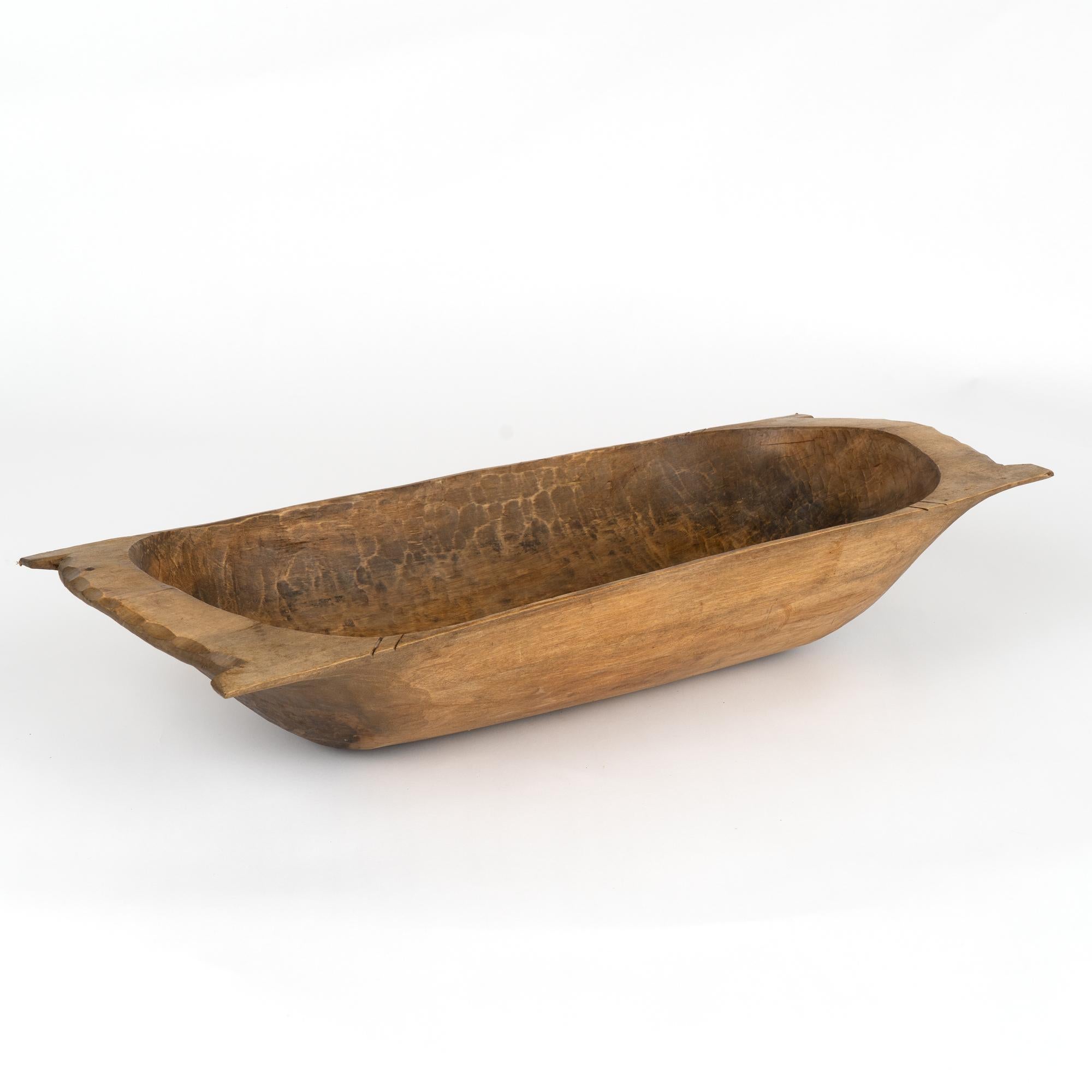 Antique, hand hewn, European country dough bowl / trencher featuring a rounded rectangular shape, tapered base and handles.
Old cracks/nicks, stains reflective of generations of use. Waxed, solid, stable and ready to be used as decorative