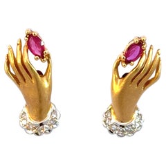 Hand Holding Ruby Diamond Earrings 18K Yellow Gold