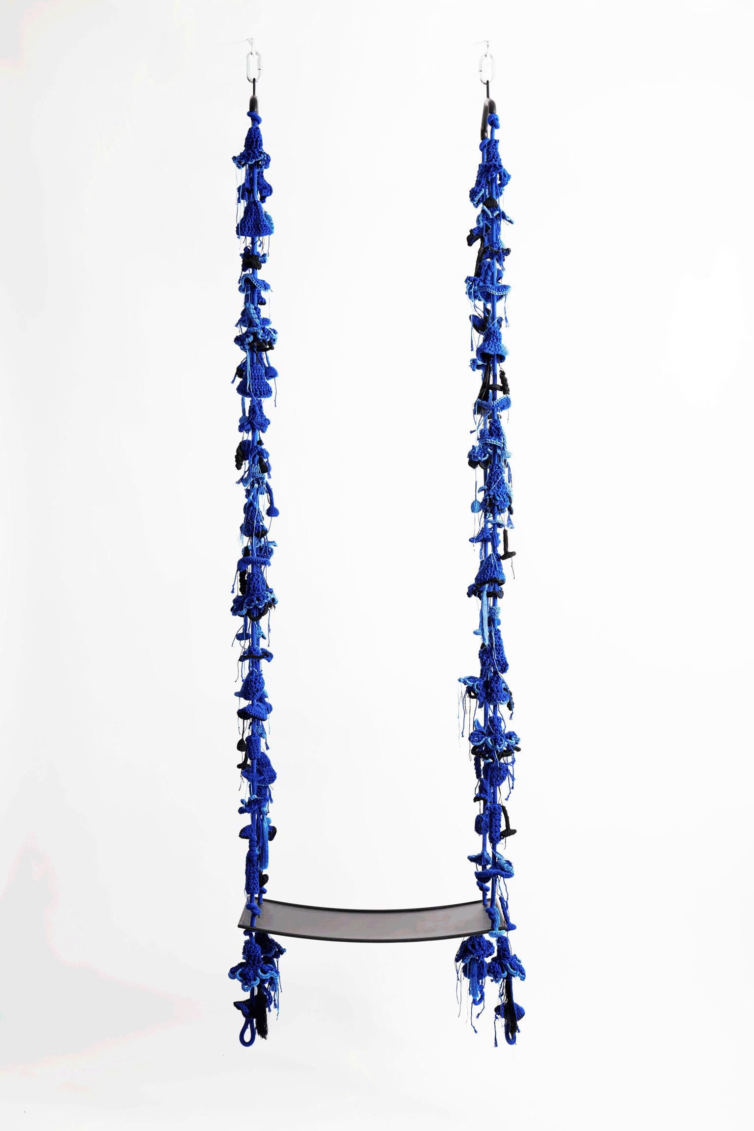 The royal blue iota swing, inspired by climbing plants, takes the user to a wild, natural, fantastic place. The swing showcases much of our special knitted hand work. The numerous intricate elements that form the swing are hand knit with bespoke