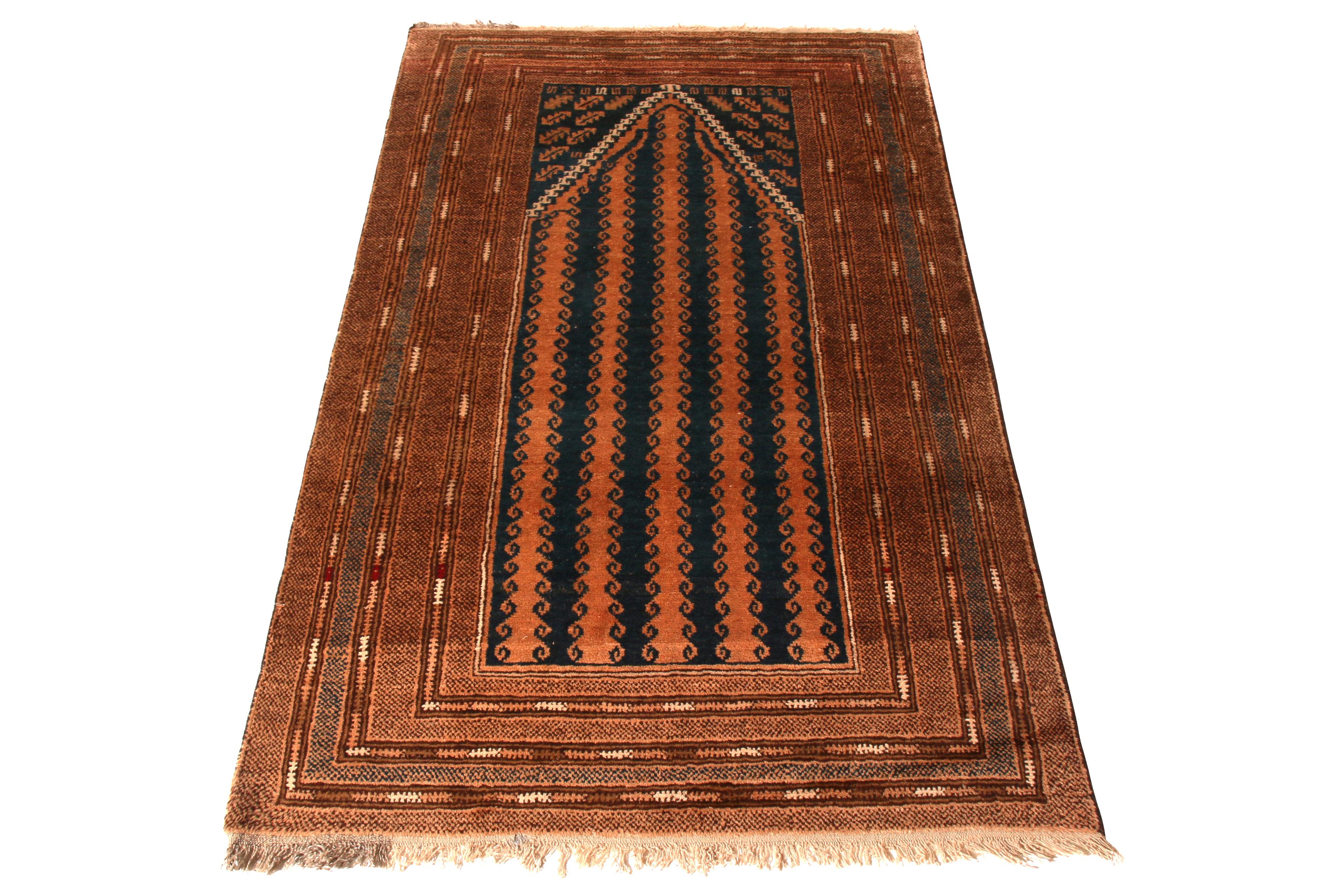 Hand knotted in wool originating from the Baluch tribal weavers circa 1950-1960, this midcentury vintage Persian rug enjoys a unique colorway approach to the venerated Mihrab pattern, both in the peach-orange accent as well as the remarkably subtle