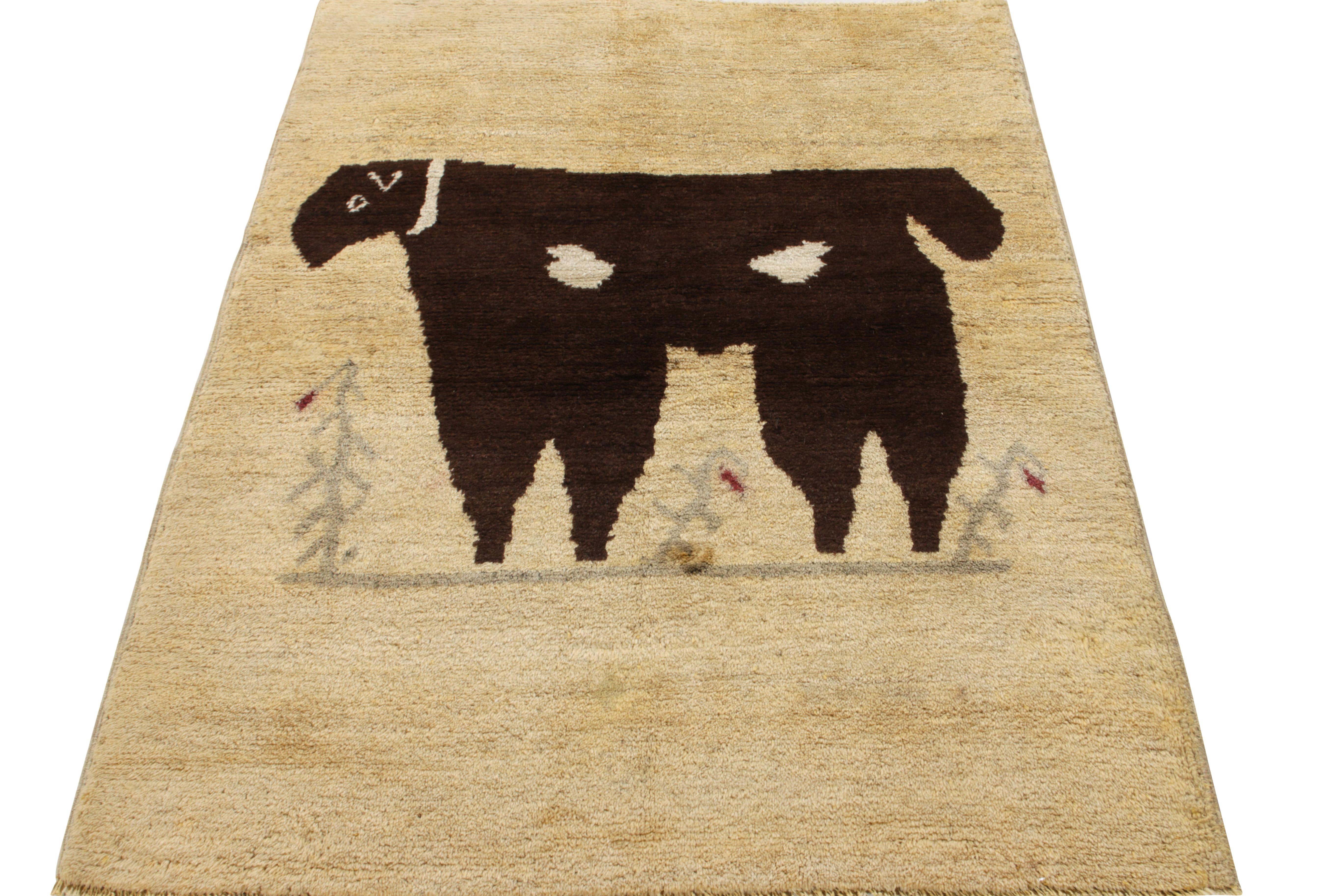 Hand-knotted in wool originating from Turkey circa 1950-1960, a rare vintage mid-century pictorial rug in beige and brown colors. Enjoying a tasteful abrash in the background and field, the medallion pictorial appears to depict a lamb or similar