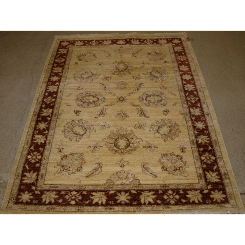 Hand knotted Afghan chobi 'Ziegler' design rug.

Pleasing 19th century floral design on an attractive antiqued ivory coloured back ground with the border design in burgundy red.

Excellent condition, hand washed and ready for use. The rug is