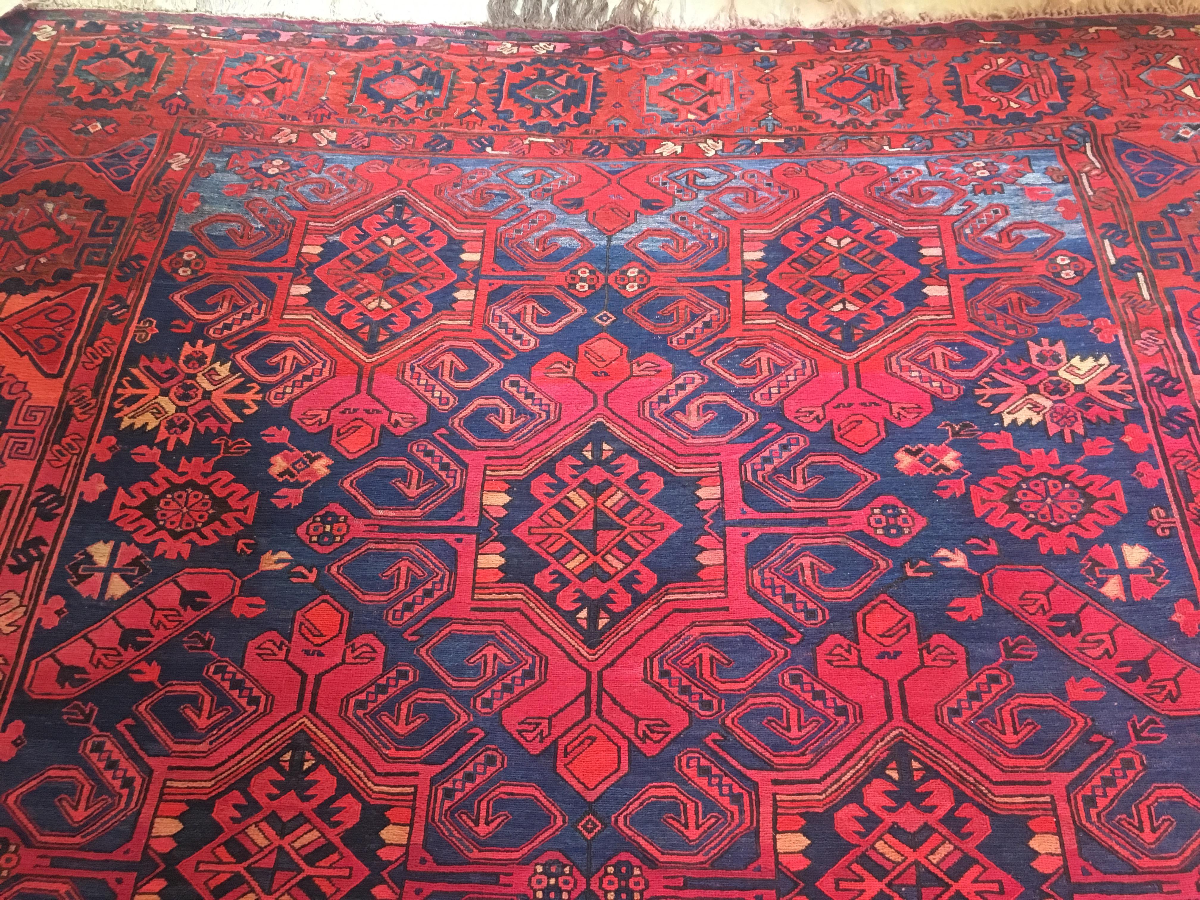 Large tribal carpet or rug with magnificent vivid colors and interesting Art Deco motifs. A wonderful example displaying a vibrant tribal sensibility, carpets like this also draw upon the classical weaving traditions from earlier centuries. 

This