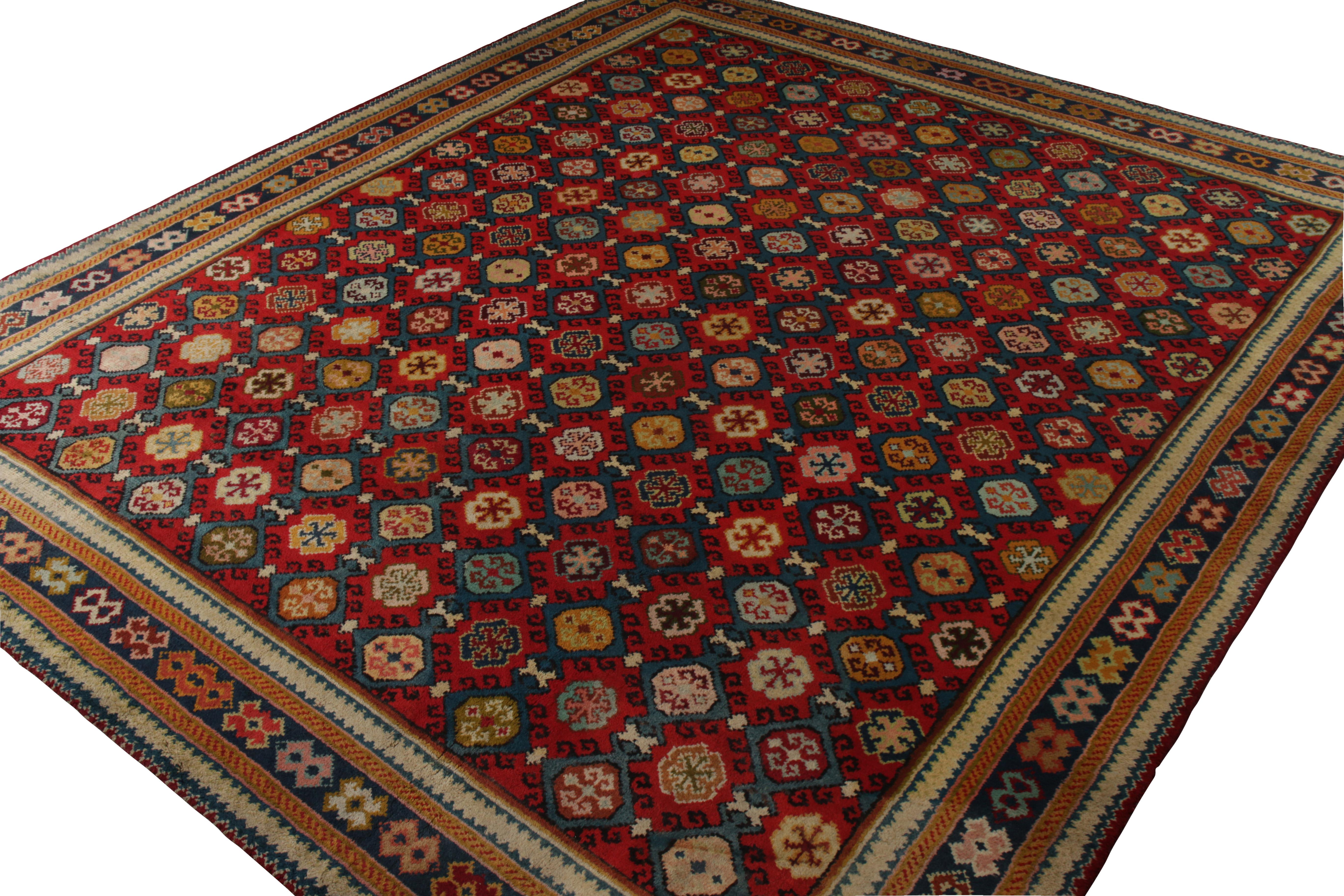 An antique 13x16 Axminster rug in blue and red, hand knotted in wool originating from England circa 1910-1920. Exemplifying handmade carpets of this period in the movement born in married color and all over geometric patterns. Enjoying a comfortable