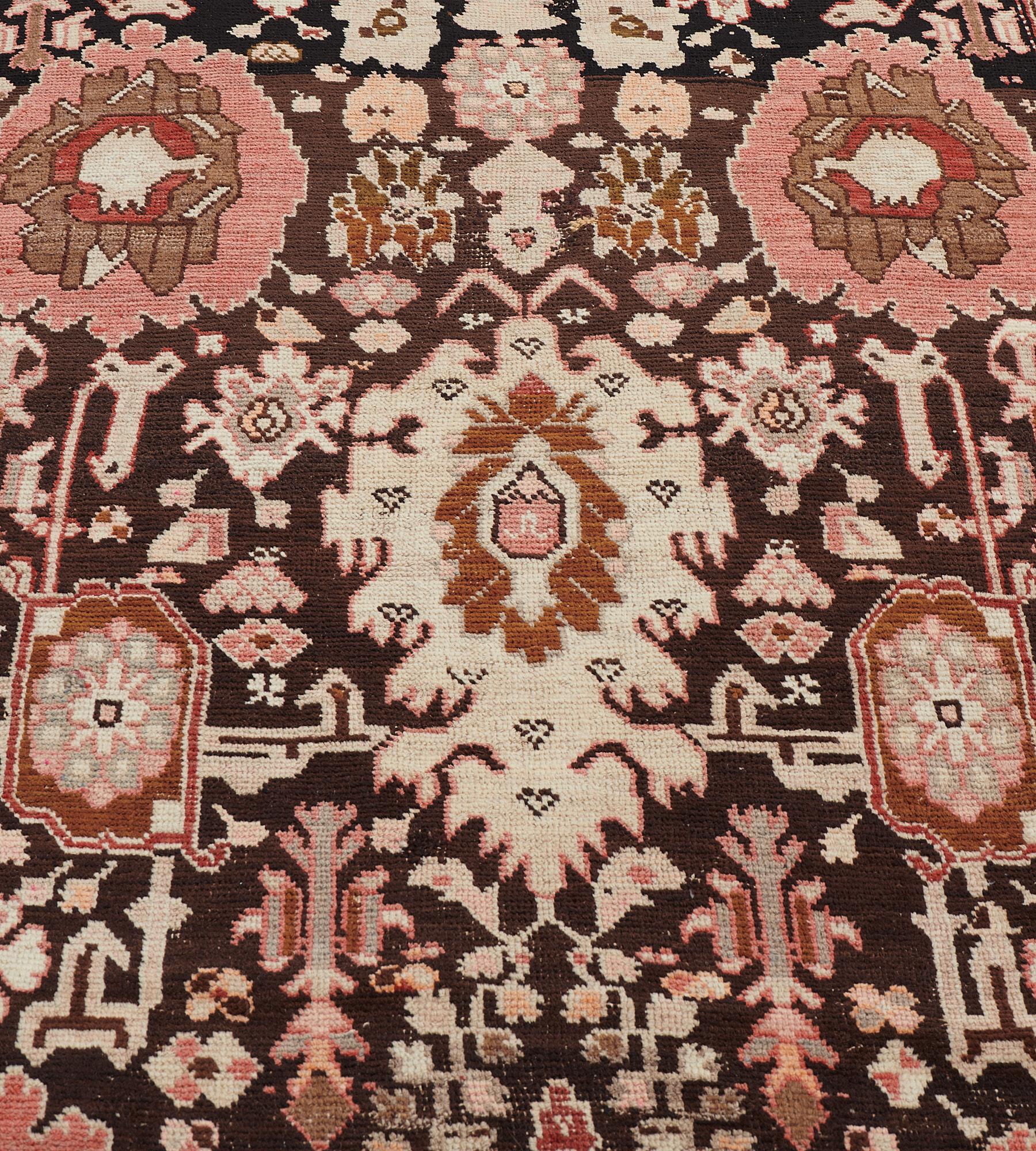 This antique, circa 1890, Karabagh runner has a chocolate-brown field with an overall design of bold brick-red, mole-brown and terracotta-red palmettes linked by angular floral vine and tiny animal figures, in a brick-red border of angular floral