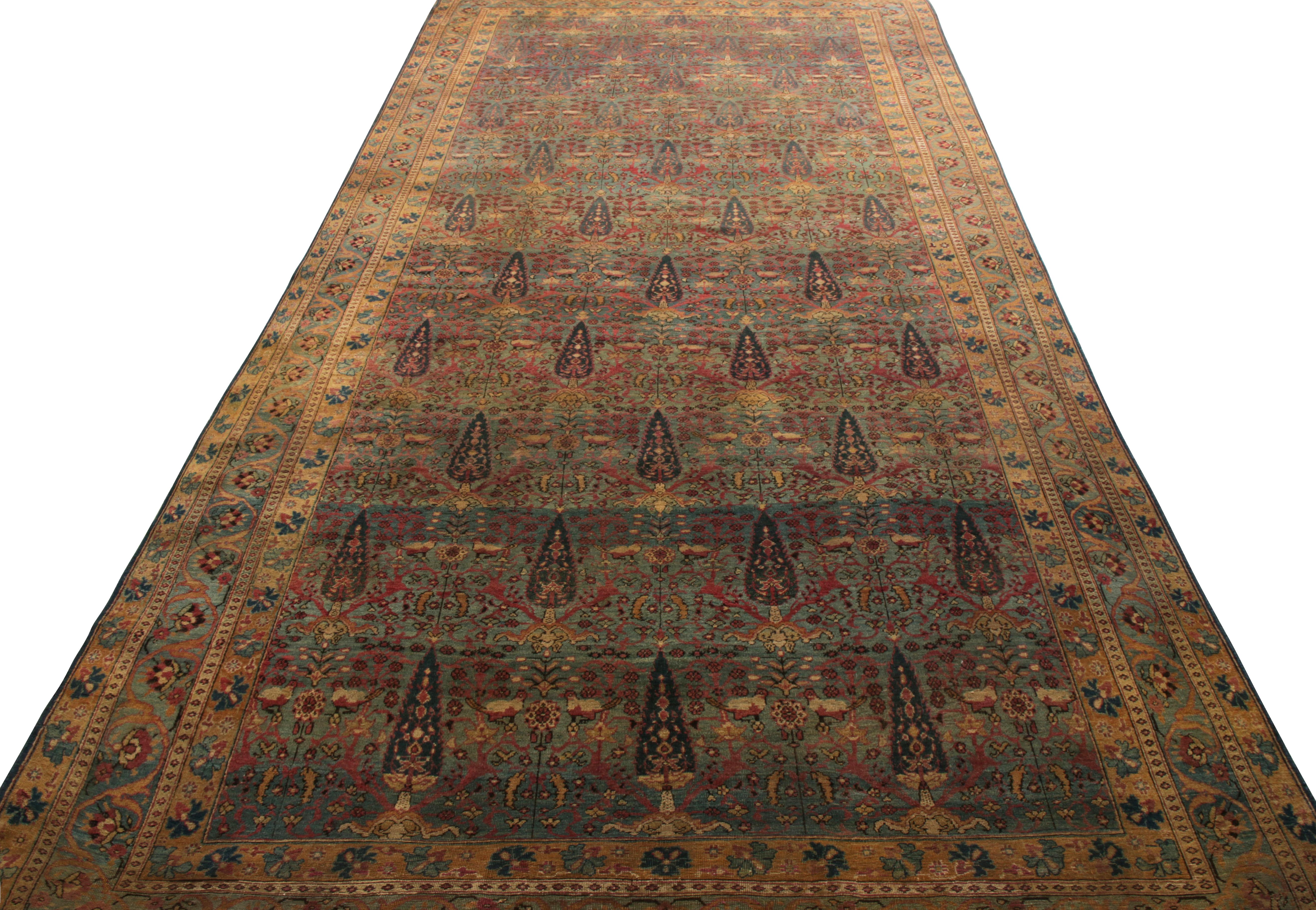 Hand knotted in wool circa 1920-1930, an antique Persian 7 x 14 Kerman Lavar rung joining Rug & Kilim’s Antique & Vintage Collection. This collectible enjoys a rich beige-brown and blue colourway with hints of pink on the field to accent a cypress