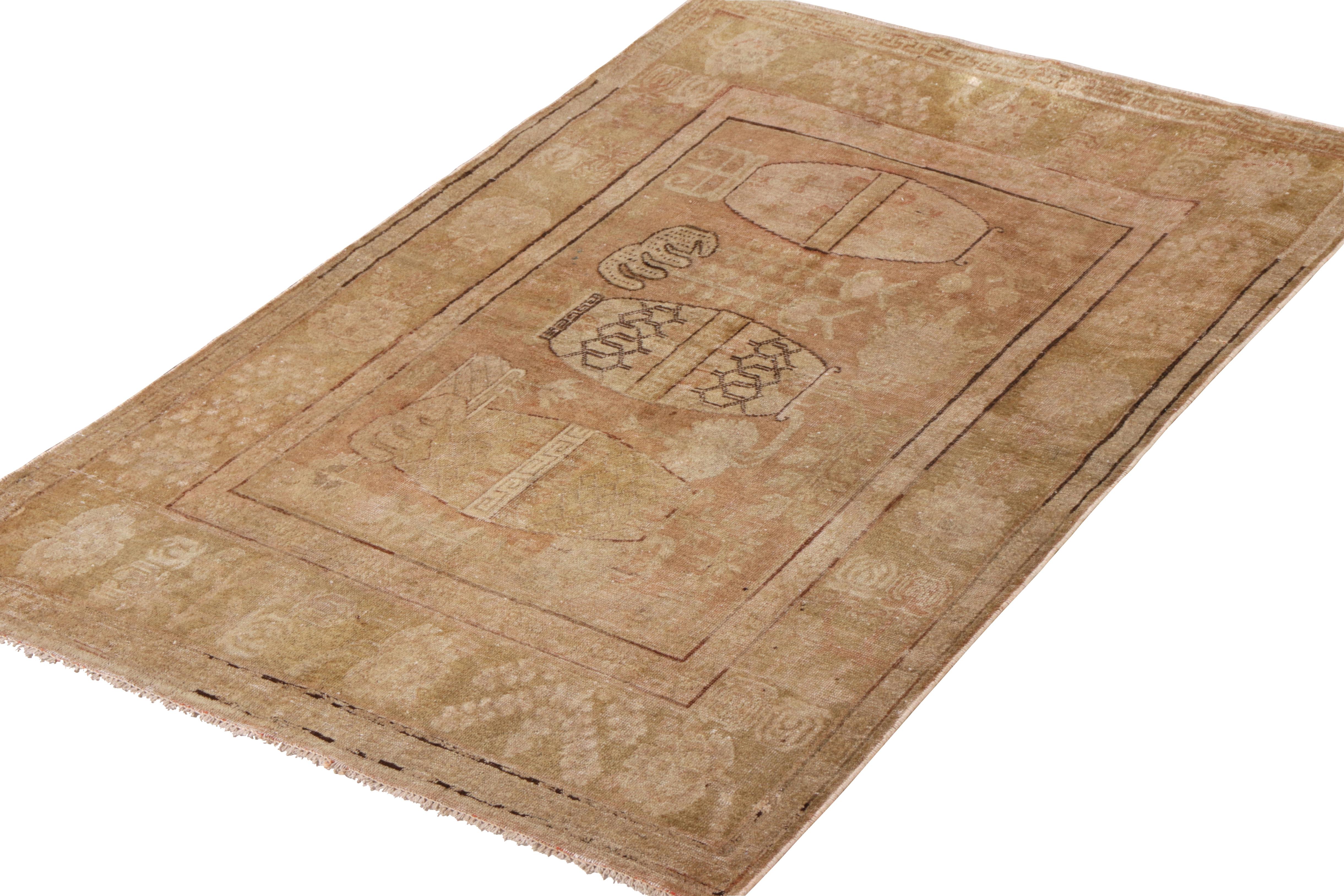 An antique 4 x 7 Khotan rug in a rare pictorial design—hand-knotted in wool circa 1920-1930 from East Turkestan. Enjoying further distinction in a subtle pink accent in the beige-brown colorway, uniquely complementing the classic look. 

Further