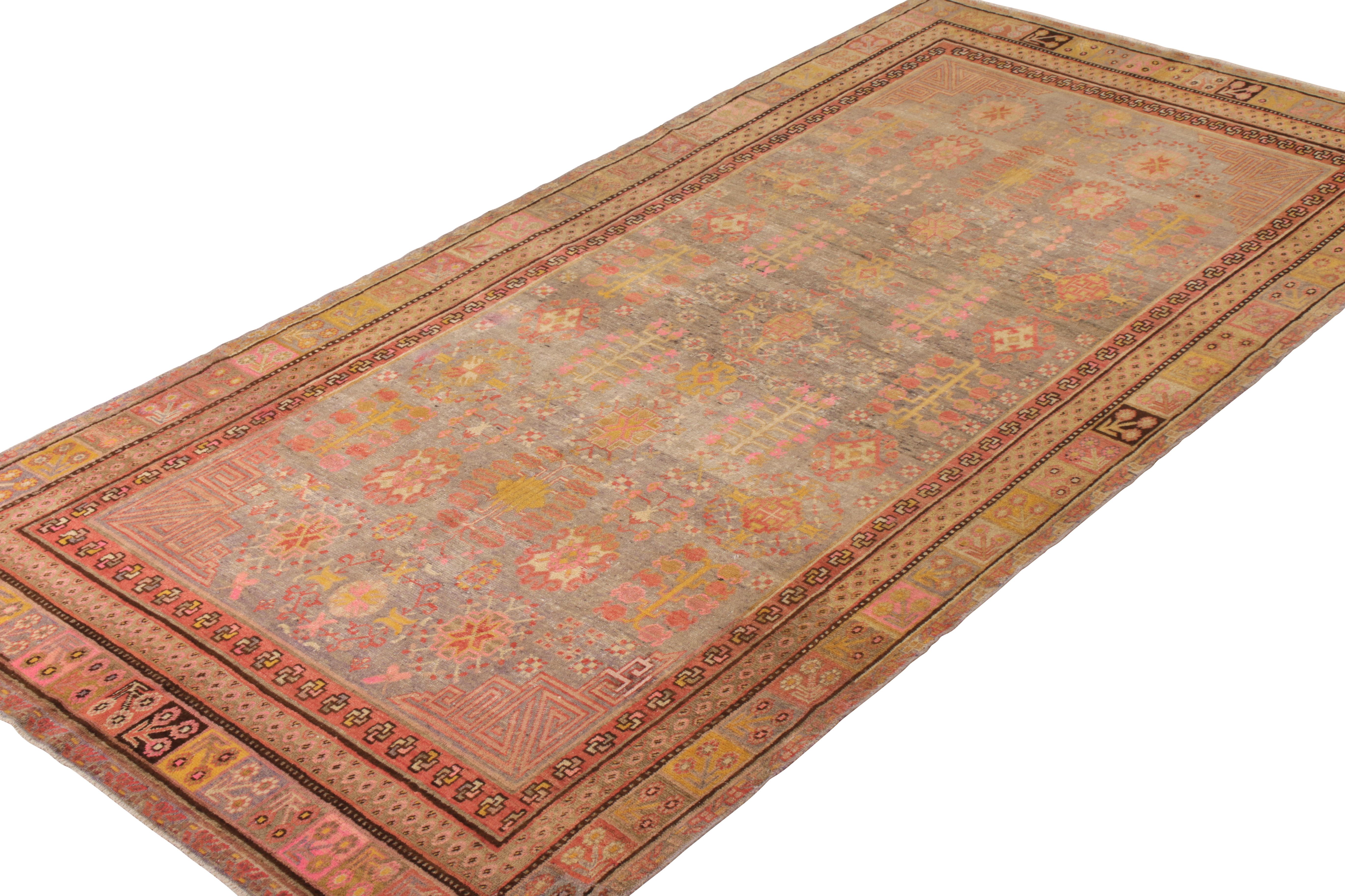 An antique 7x13 Khotan rug of unique transitional style, hand knotted in wool originating from East Turkestan circa 1920-1930. Playing hues of gold and pink atop an abrashed gray-blue, bringing life to an elegant all over pattern.

Further on the