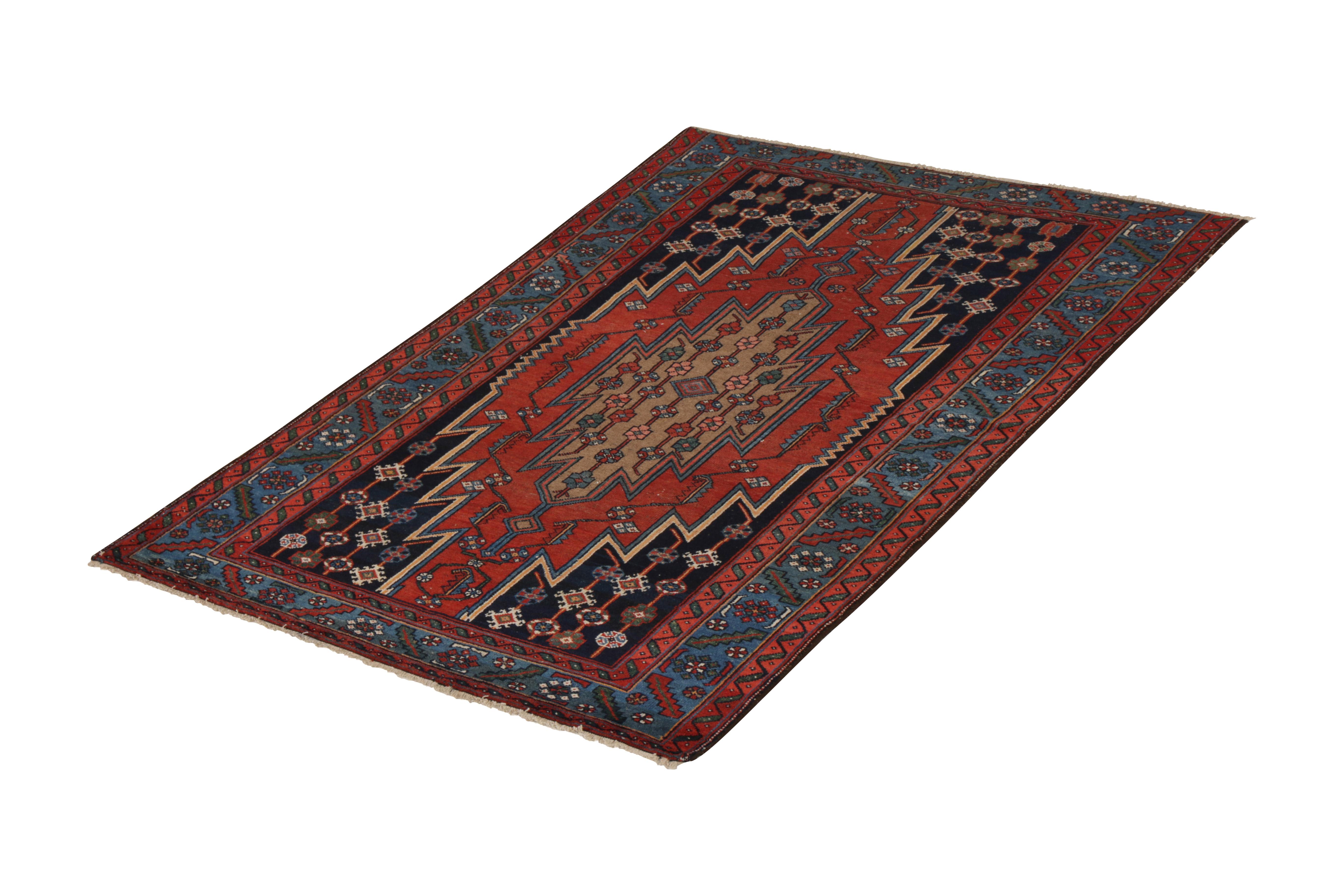 Hand knotted in wool originating circa 1910-1920, this antique Persian rug connotes an early 20th century Mazlaghan rug design, a distinctive lineage among Classic Persian rugs known among many traits for expressive medallion patterns like this red