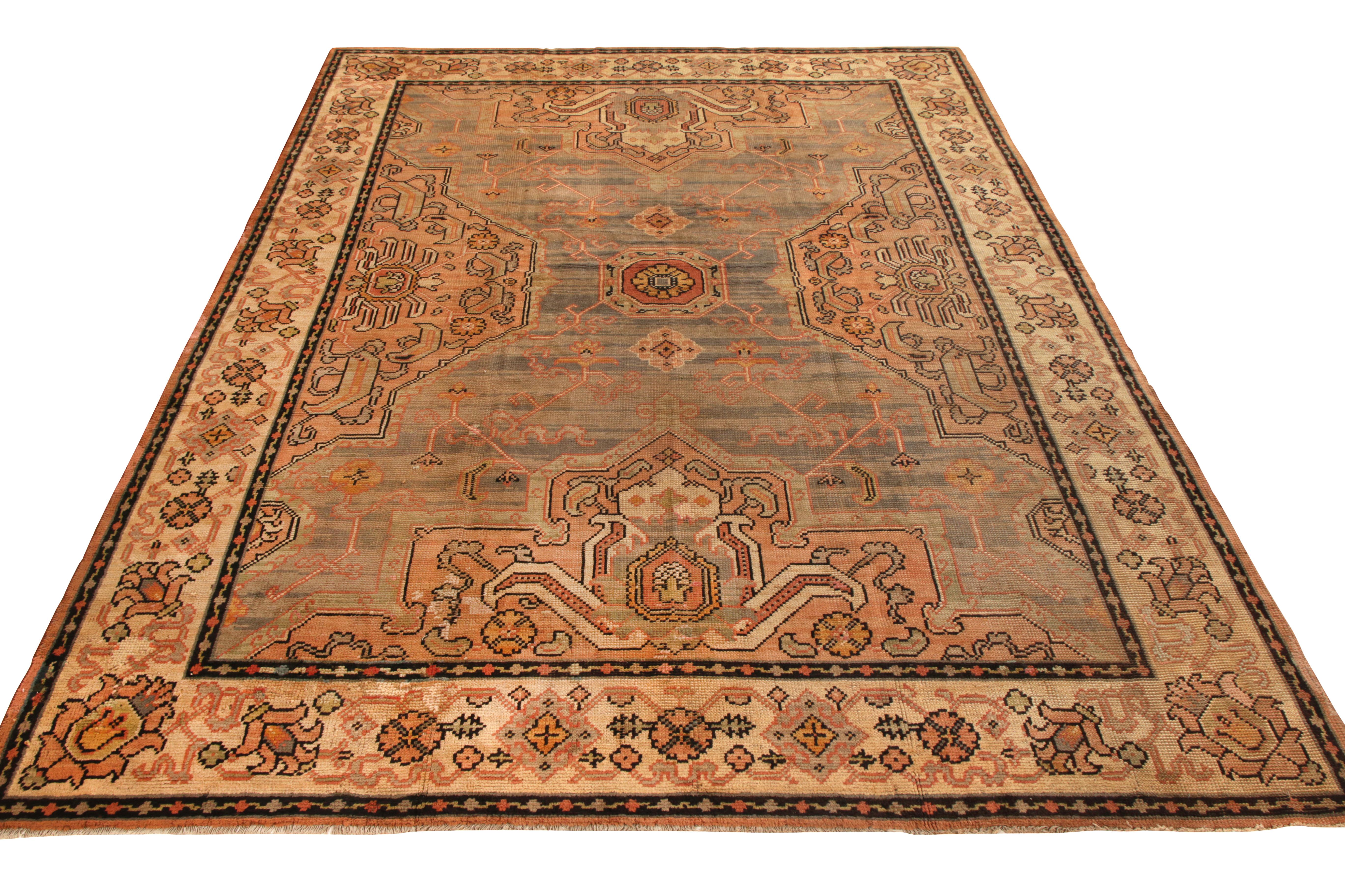 A 10 x 13 ode to rare antique Oushak rug styles, hand knotted in wool originating from Ireland circa 1920-1930. Representing a unique European take on celebrated Oushak designs, an opulent medallion floral pattern enjoys a play of beige-brown and