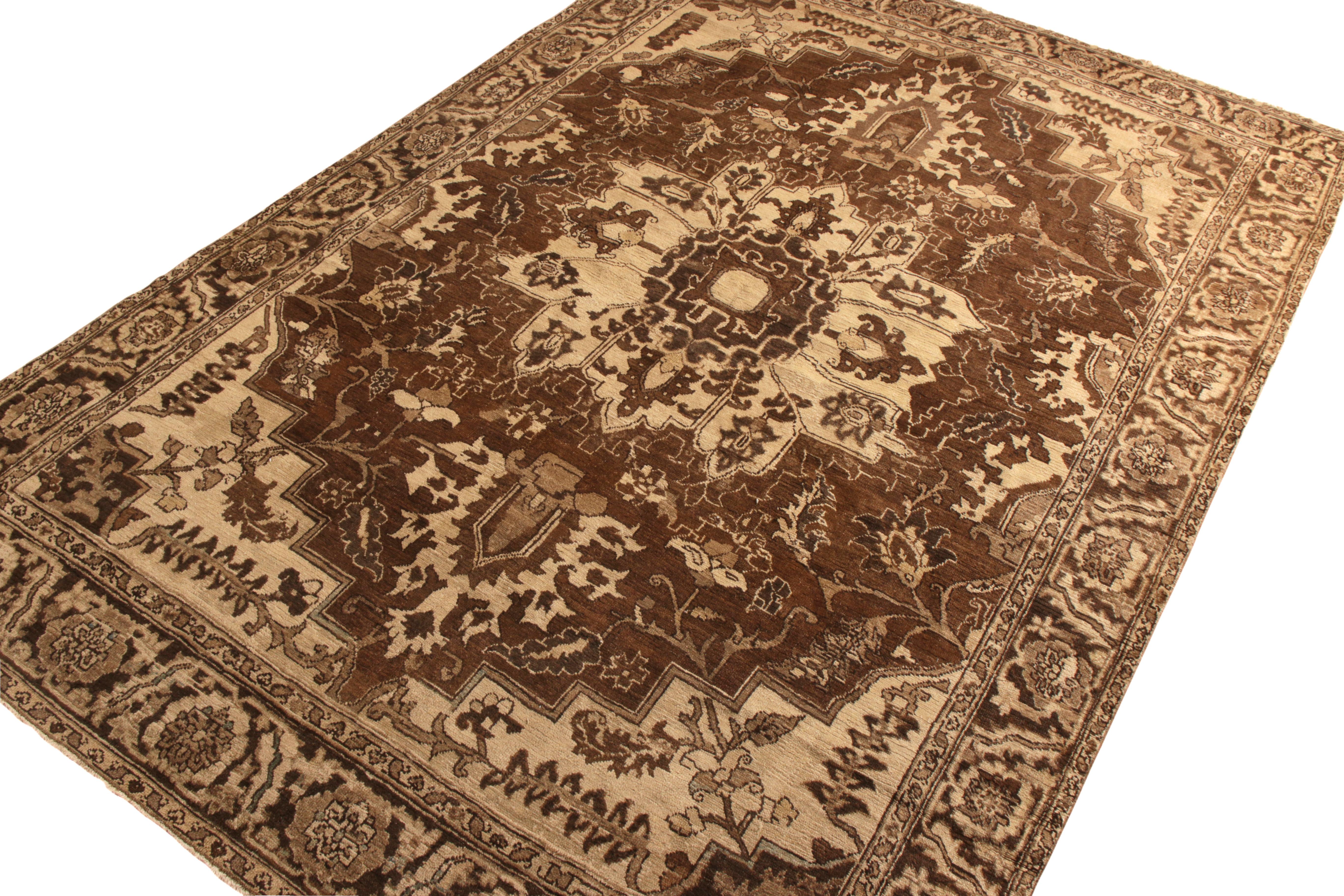 A beautifully rich beige-brown antique Persian Heriz rug joining Rug & Kilim’s Antique & Vintage collection. Hand knotted in wool circa 1920-1930, the rug witnesses a blissful marriage of beautiful rich floral and medallion style, sitting with a