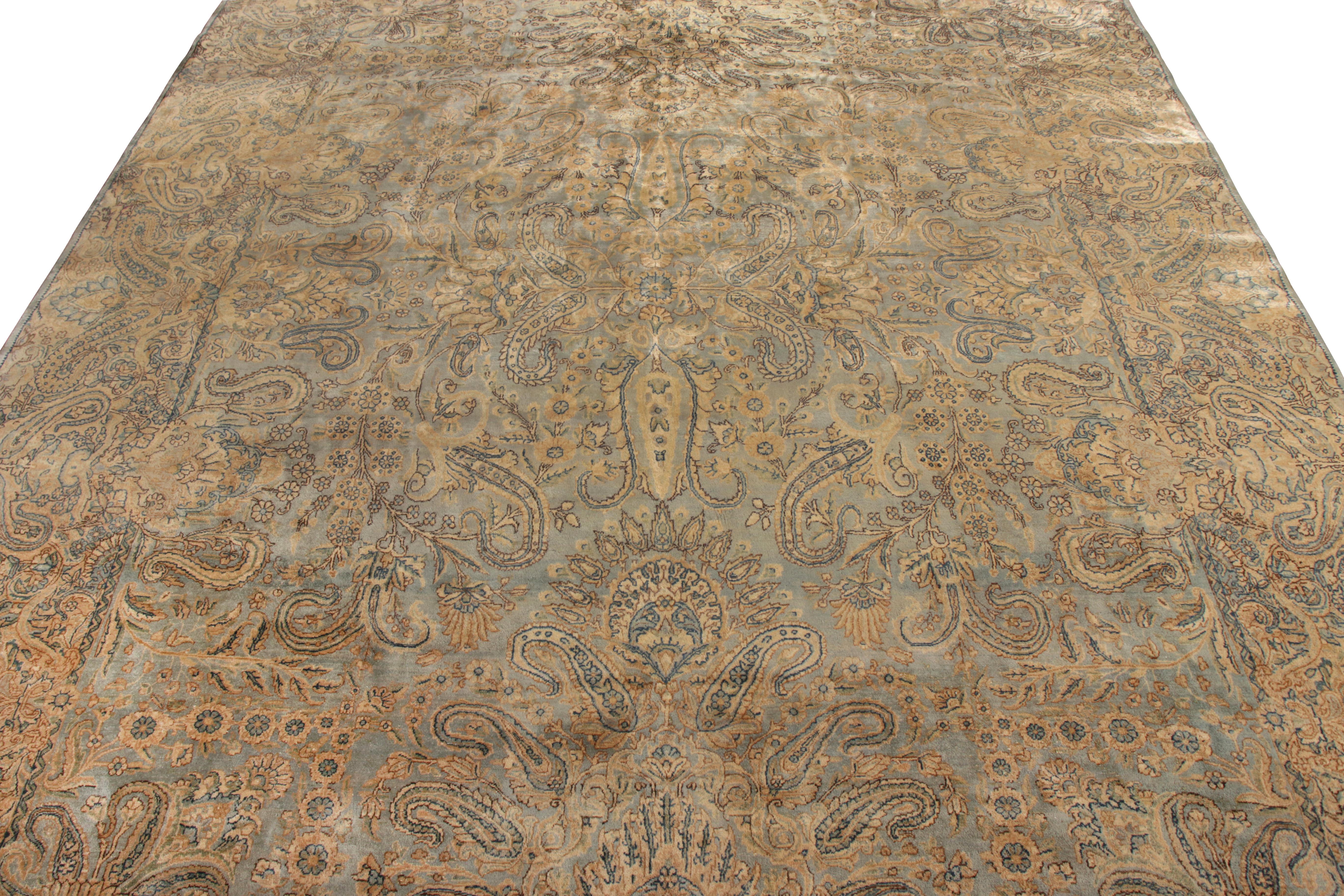 Hand knotted in wool circa 1890-1900, this Kerman rug is a crowning glory of Persian lineage. Enjoying a regal all over floral pattern with exceptional sense of movement, this transitional style features a union of golden and frosty blue hints,