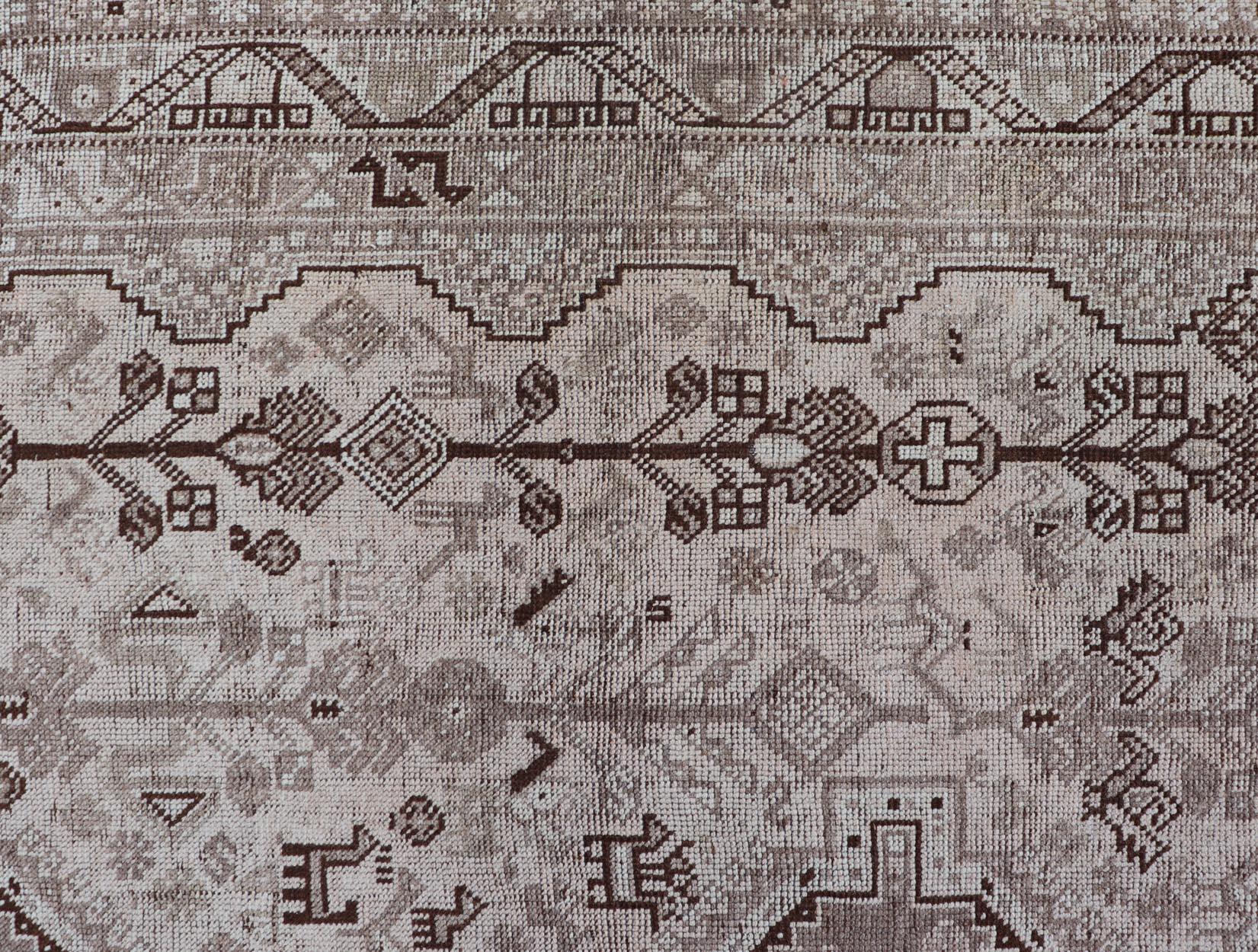 Persian Shiraz rug with vertical sub-geometric medallions in earth tones. 
rug TU-MTU-4970, country of origin / type: Iran / Shiraz, circa 1920
Keivan Woven Arts 

Measures: 7'0 x 10'0.