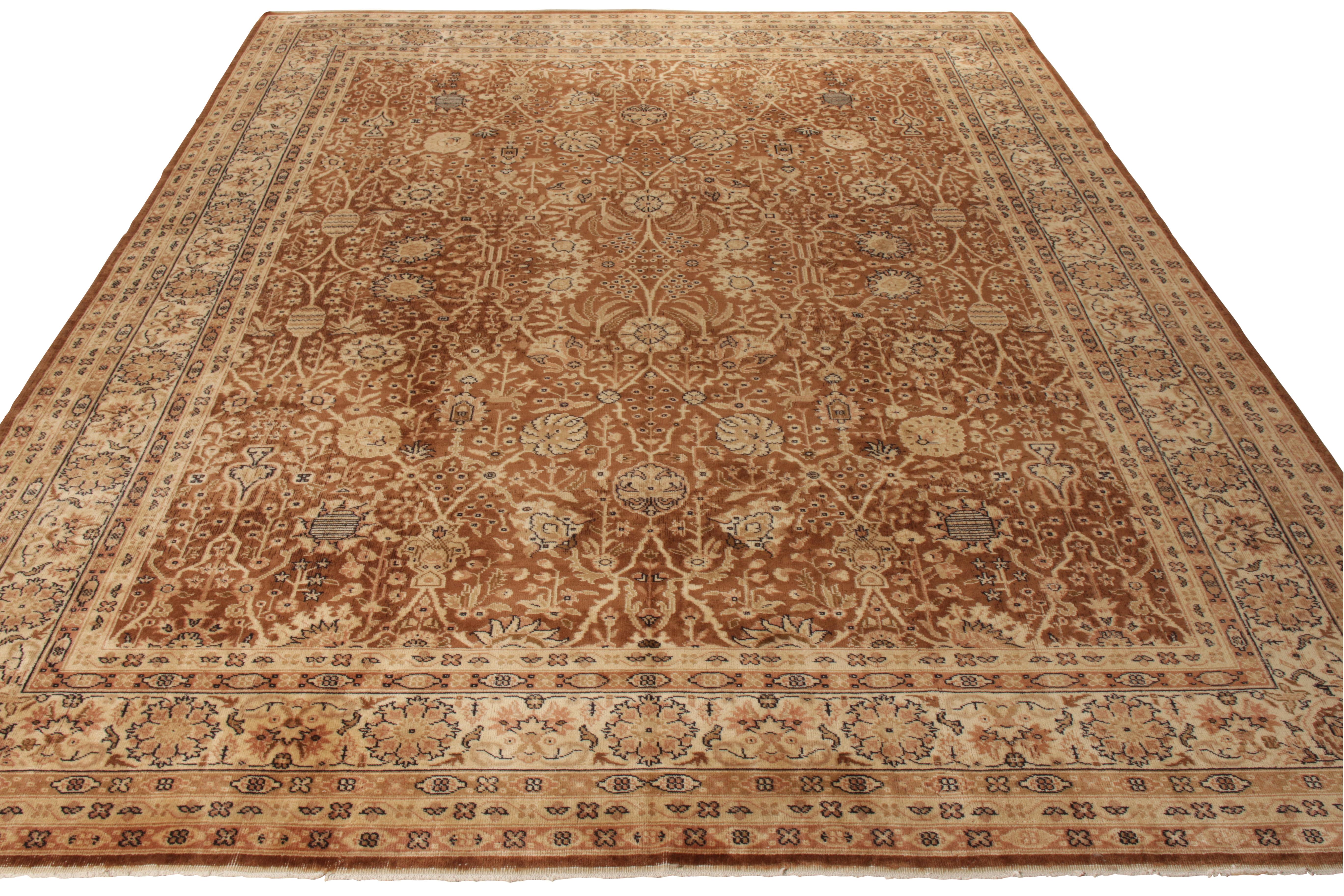 Hand knotted in wool, an exceptional antique 10x13 Samarkand rug originating from East Turkestan circa 1920-1930. Present in a luxurious colorway of brown, beige and golden tones, the rug exhibits fine craftsmanship with a dextrous floral pattern