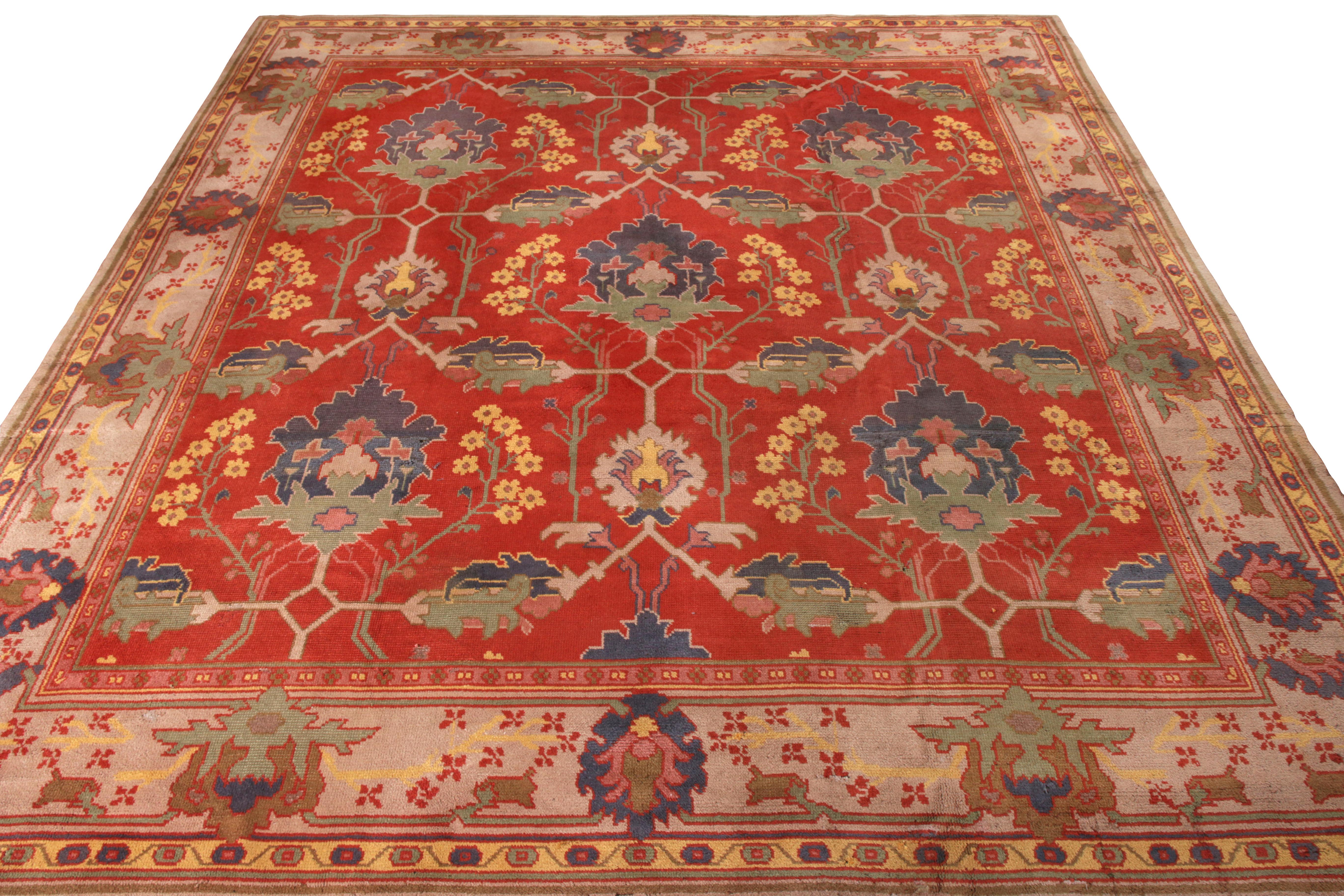 Originating from Ireland circa 1910–1920, this antique 13x14 Arts & Crafts rug is a rare work from the English works of Charles Voysey. 

On the Design: 

Hand-knotted in wool, this piece enjoys a warm, saturated red field and beige border, with