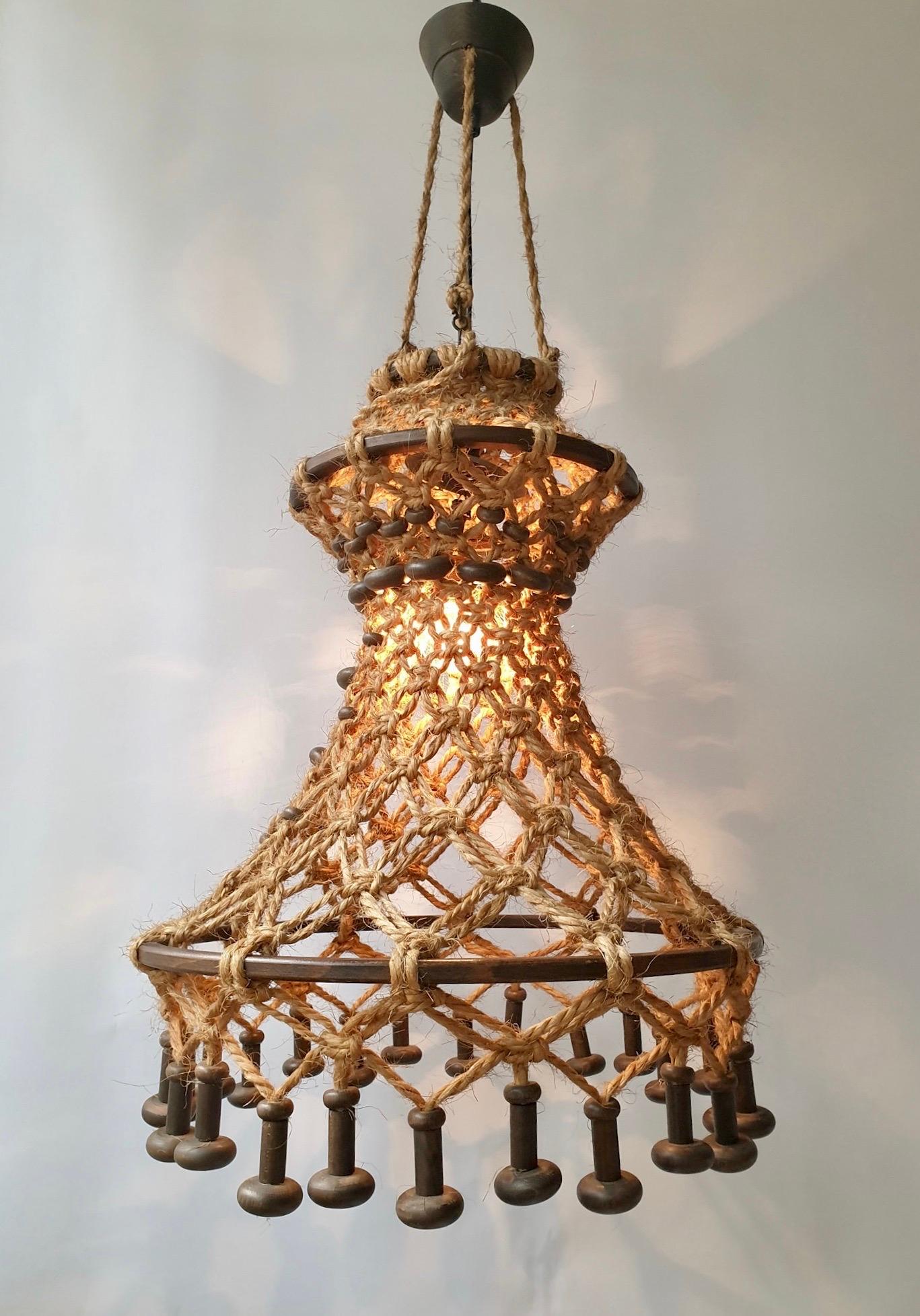 Hand knotted chandelier with natural rope and wood. This pendant light has a very natural, and organic look and feel.
This chandelier comes with a E27 fitting. Max 100W. 

Dimensions:
The rope has an extra length of 160 cm and the total height