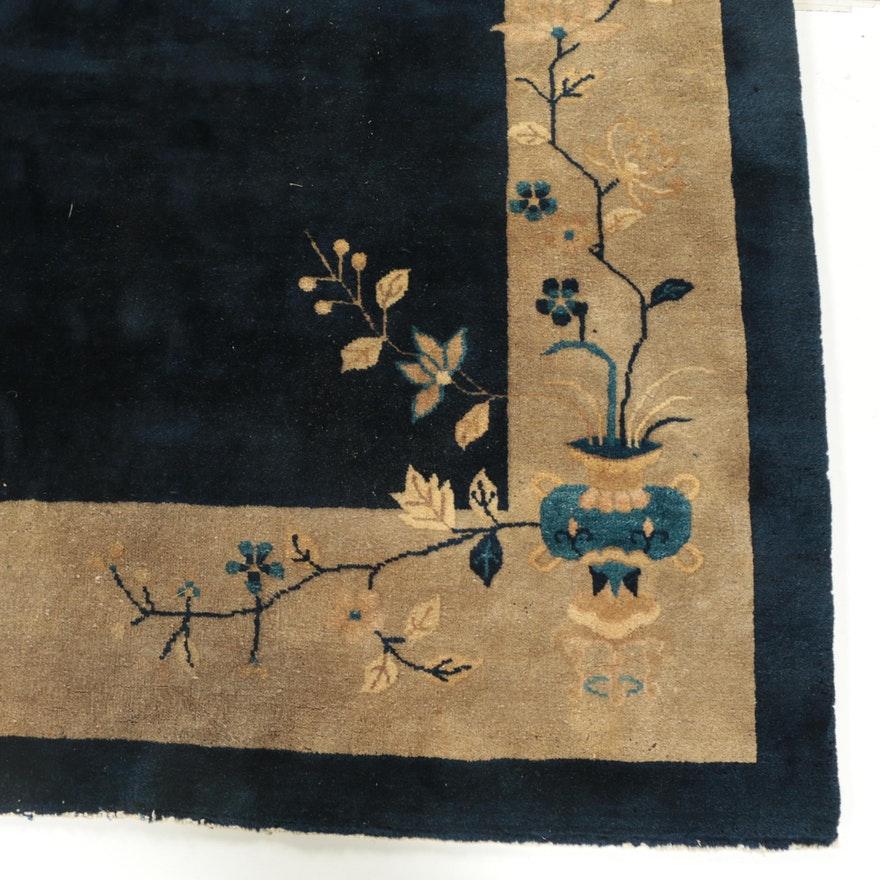 Antique hand knotted Chinese Art Deco wool room sized rug. This rug is rendered in a palette of indigo, sand, wheat, cobalt, custard, and mauve. It features an asymmetrical design of flowering and leafy branches, perched birds, vases with