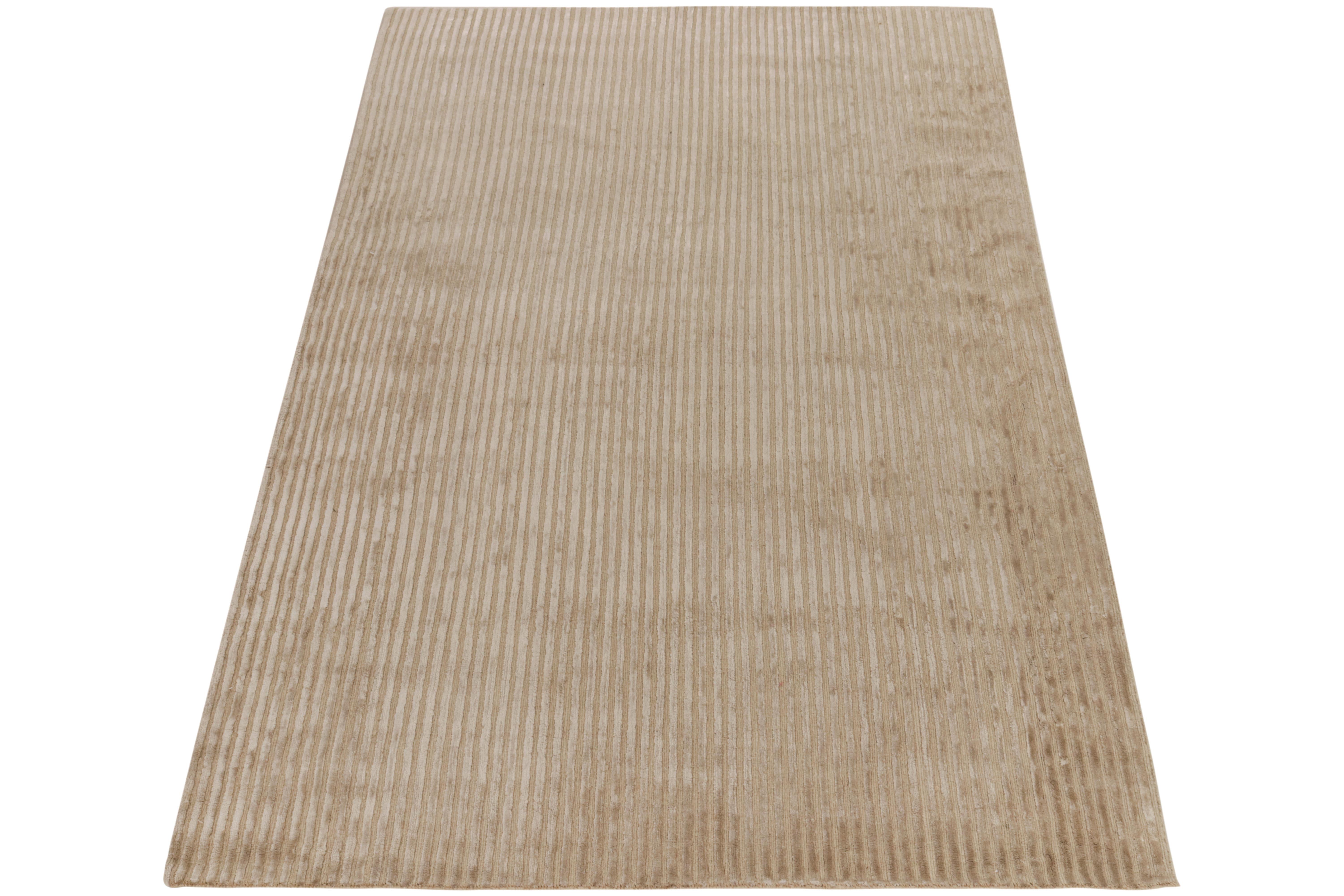 Hand-knotted in fine wool & silk, a contemporary piece from Rug & Kilim’s texture of color collection. The 4x7 rug observes a ribbed high low subtlety in delicious tones of beige complementing the natural sheen of silk. Simplistic yet luxurious, a