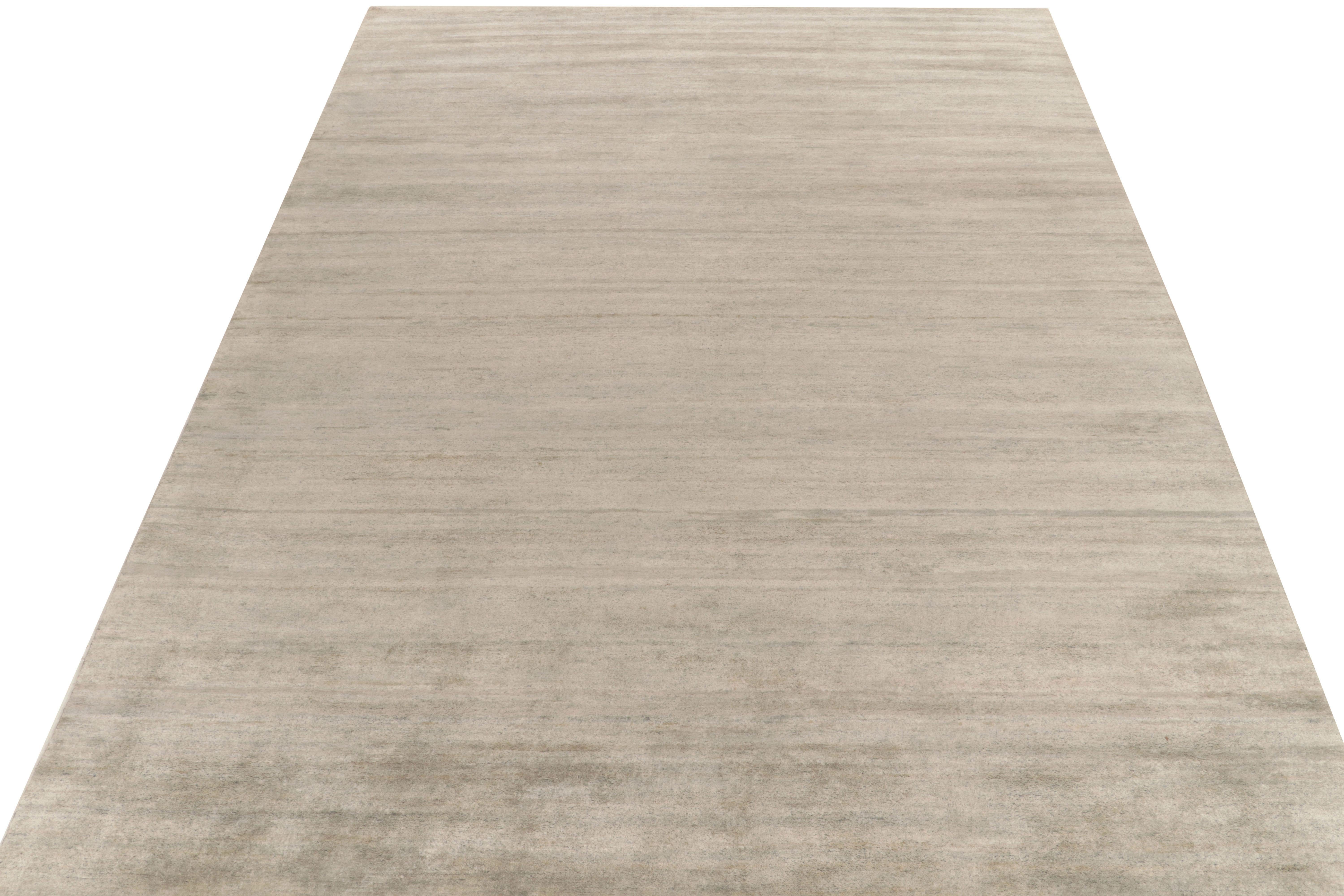 Rug & Kilim introduces its refined take on modern aesthetics with this smart, solid grey rug in 10x14 rug from our texture of color collection. The contemporary piece relishes a mature colorway of silver-grey and light blue striations—exemplifying